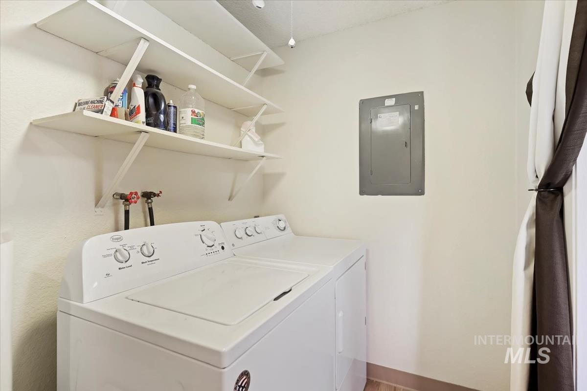 Laundry area with electric panel and washing machine and clothes dryer