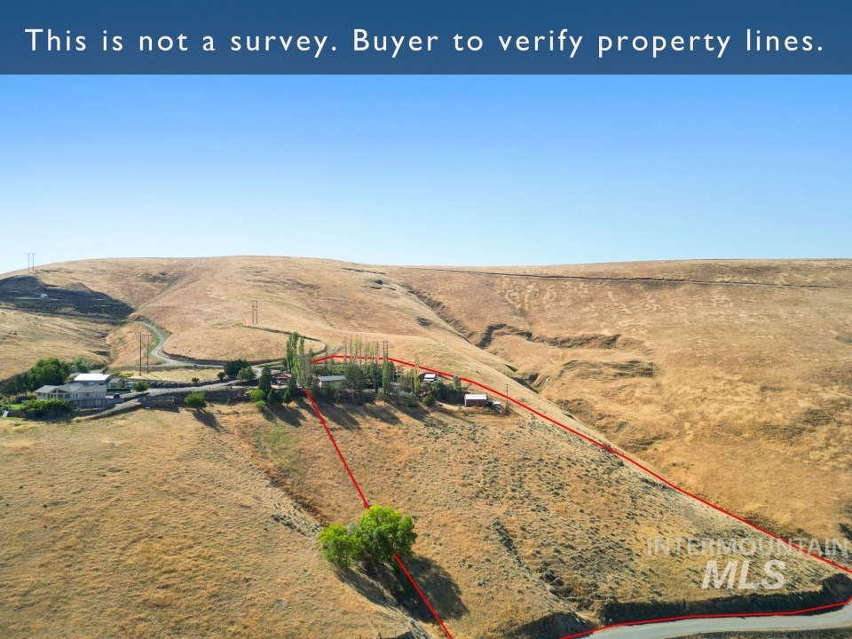 Overview of rural landscape featuring property parcel outlined and a mountainous background