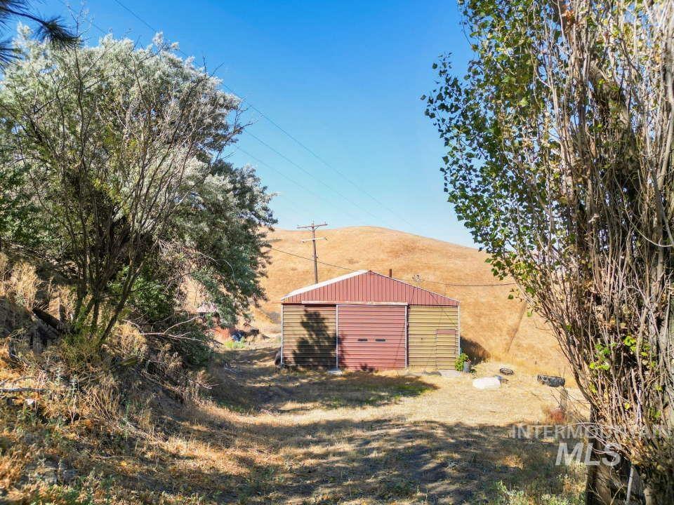 View of yard with a pole building and an outbuilding