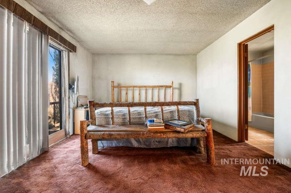 Carpeted bedroom with a textured ceiling