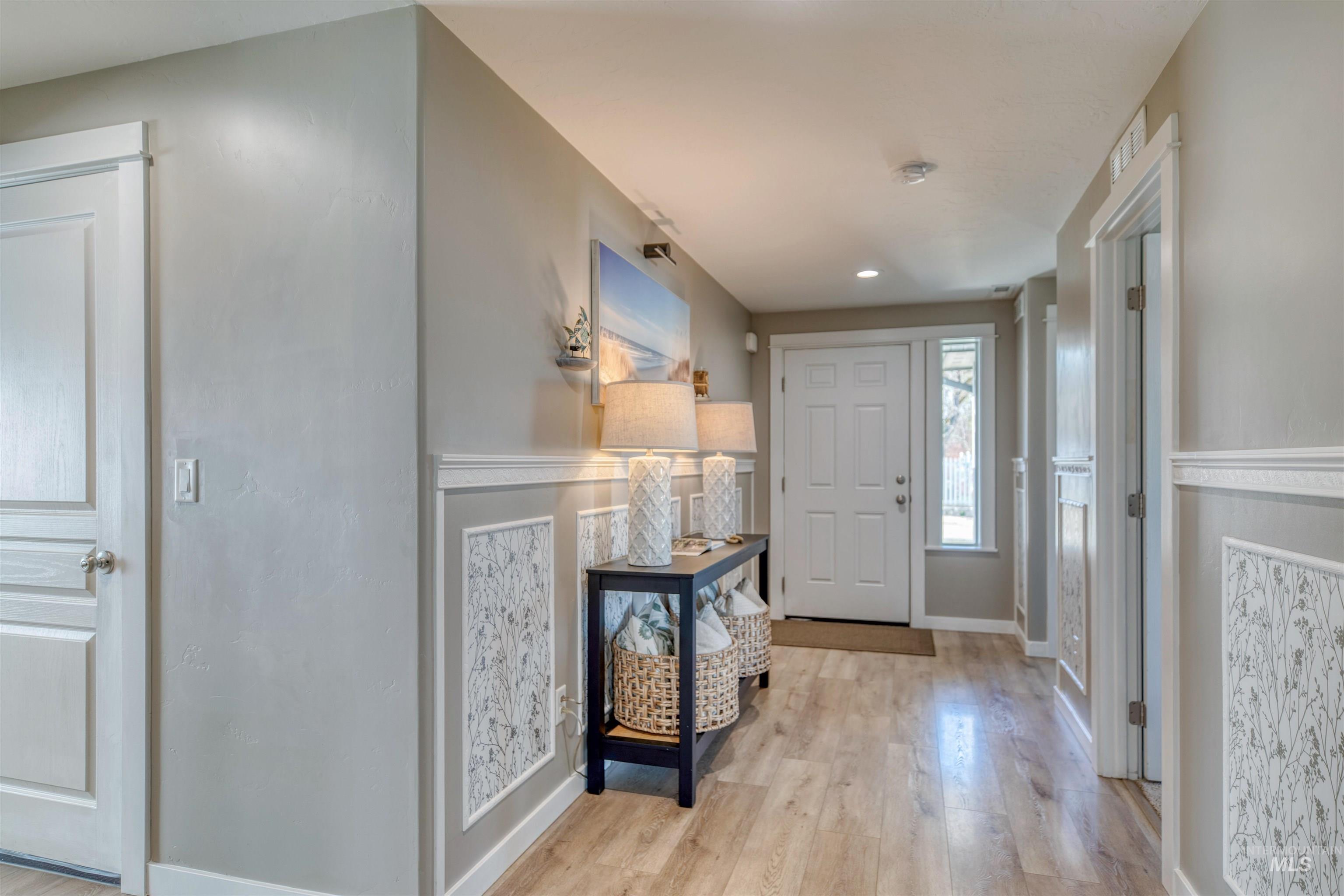 Entryway with light wood-style flooring and recessed lighting