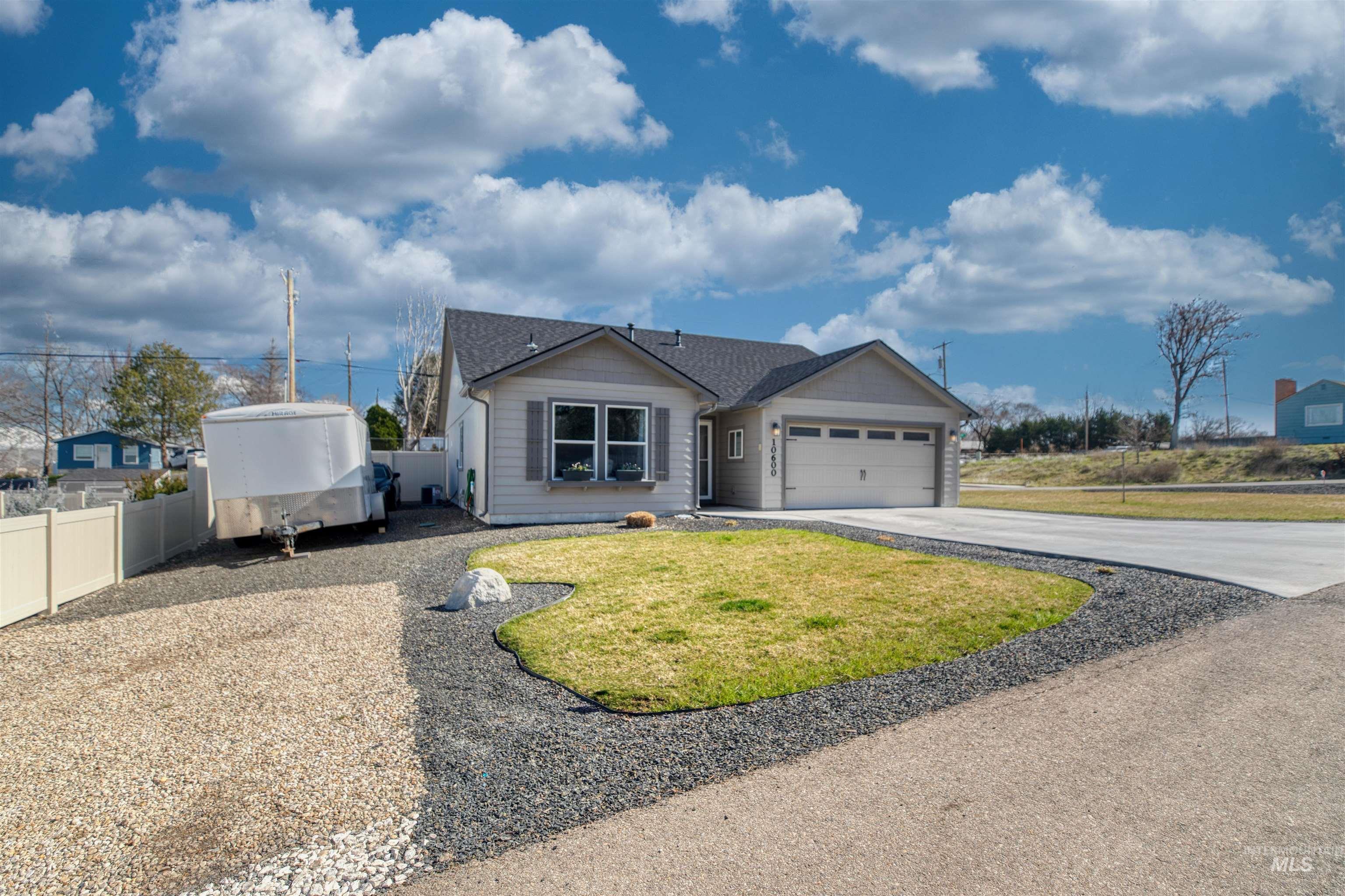 Single story home with concrete driveway and an attached garage
