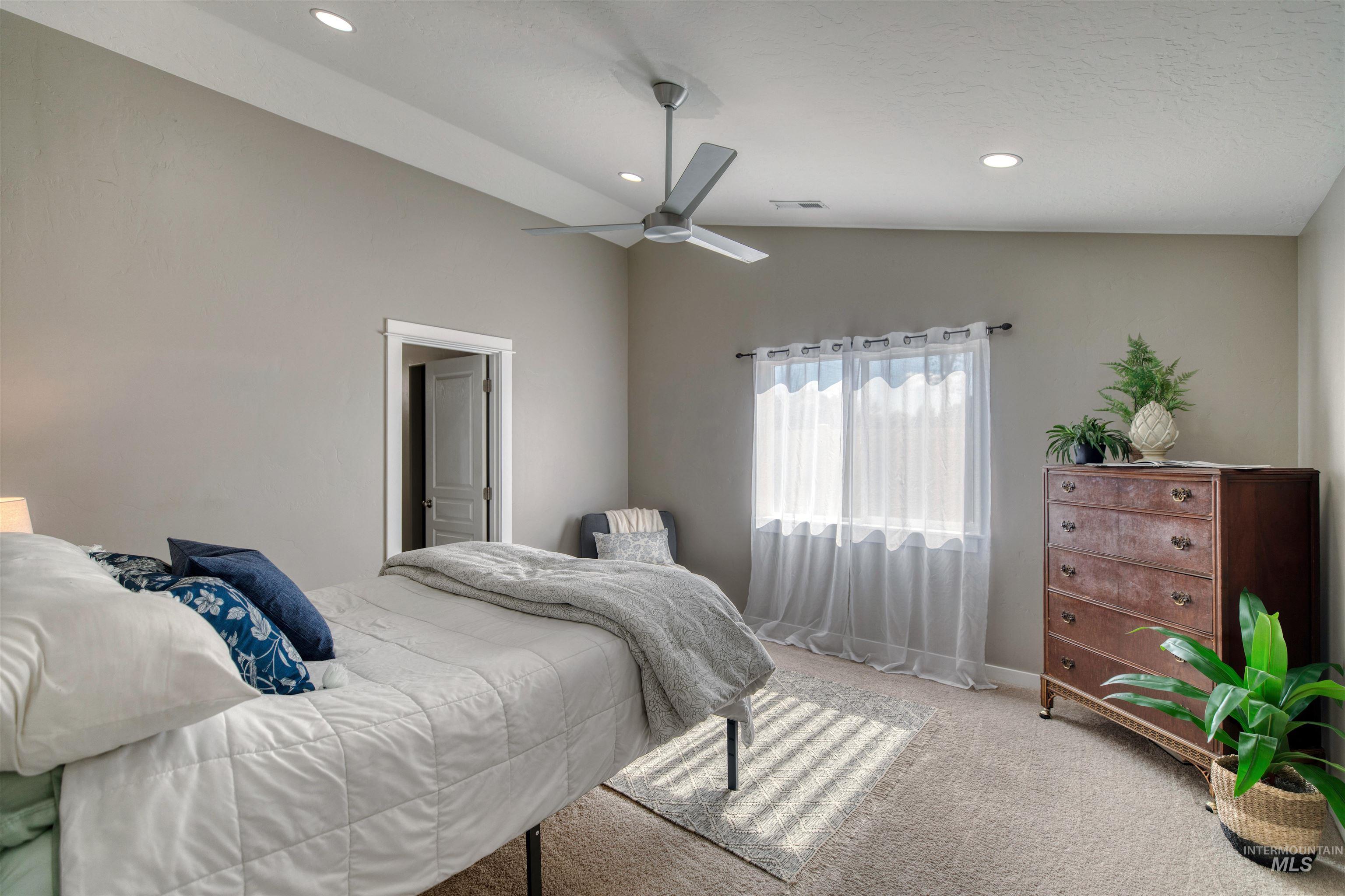 Bedroom featuring lofted ceiling, carpet, ceiling fan, and recessed lighting