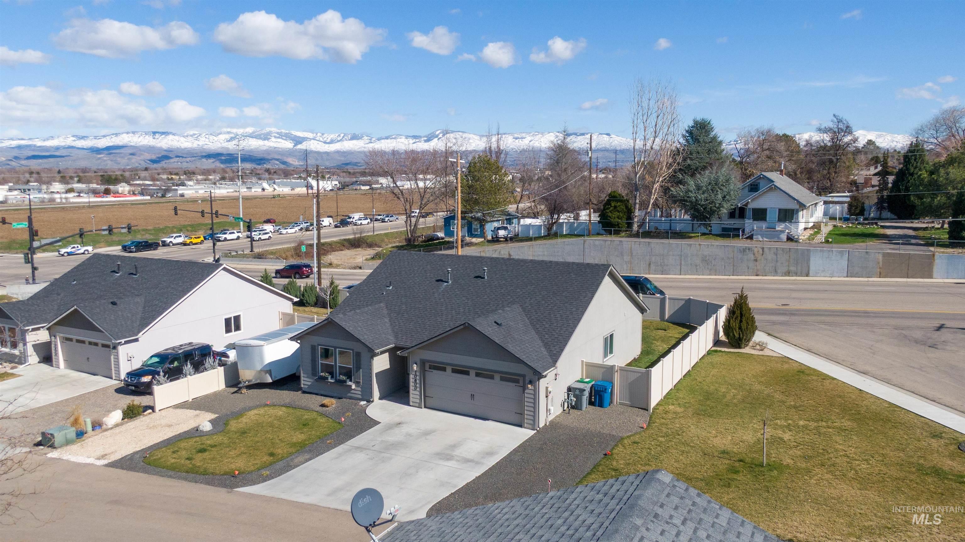 Aerial perspective of suburban area featuring a mountainous background