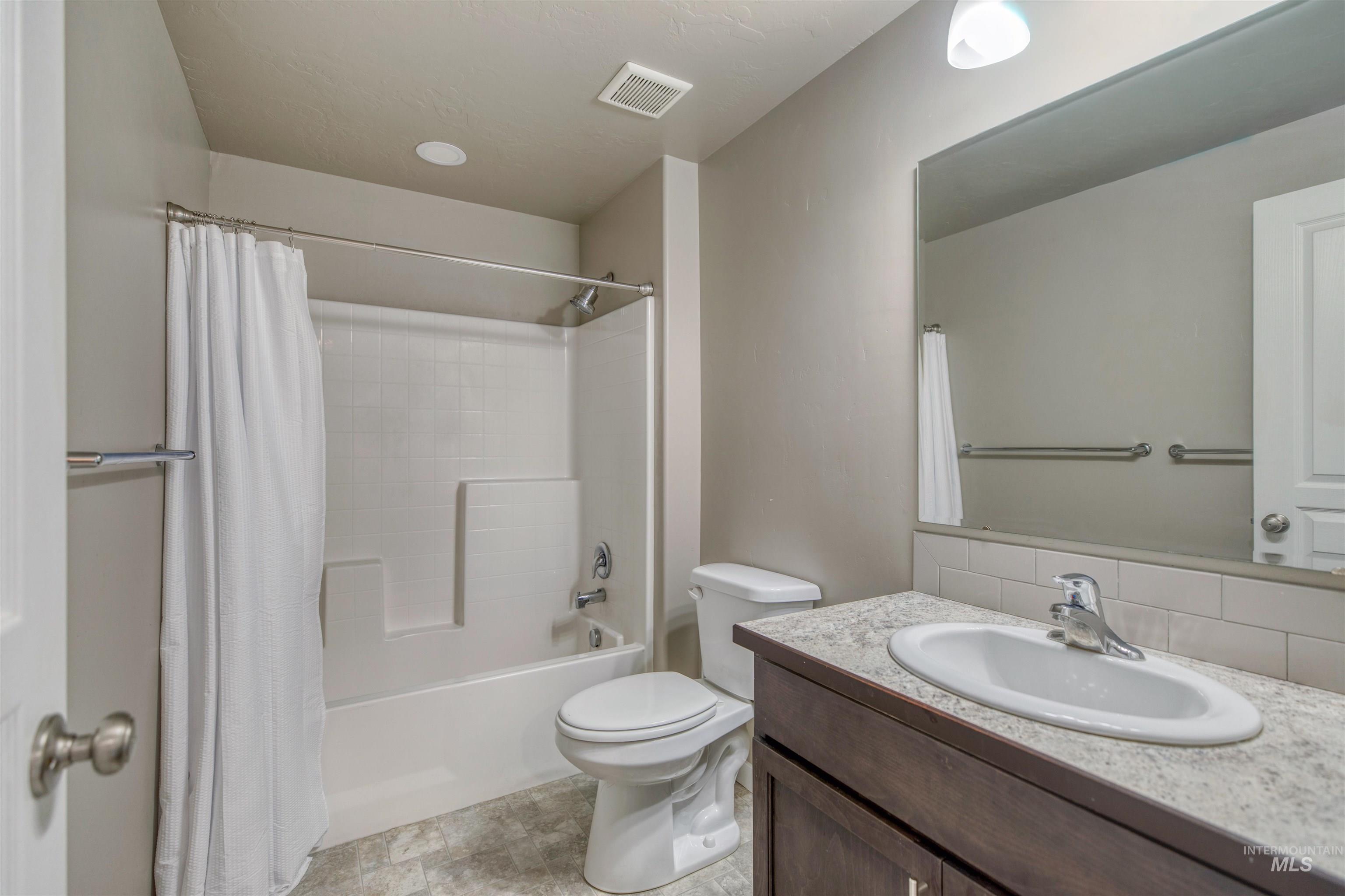 Full bathroom with vanity and shower / bath combo