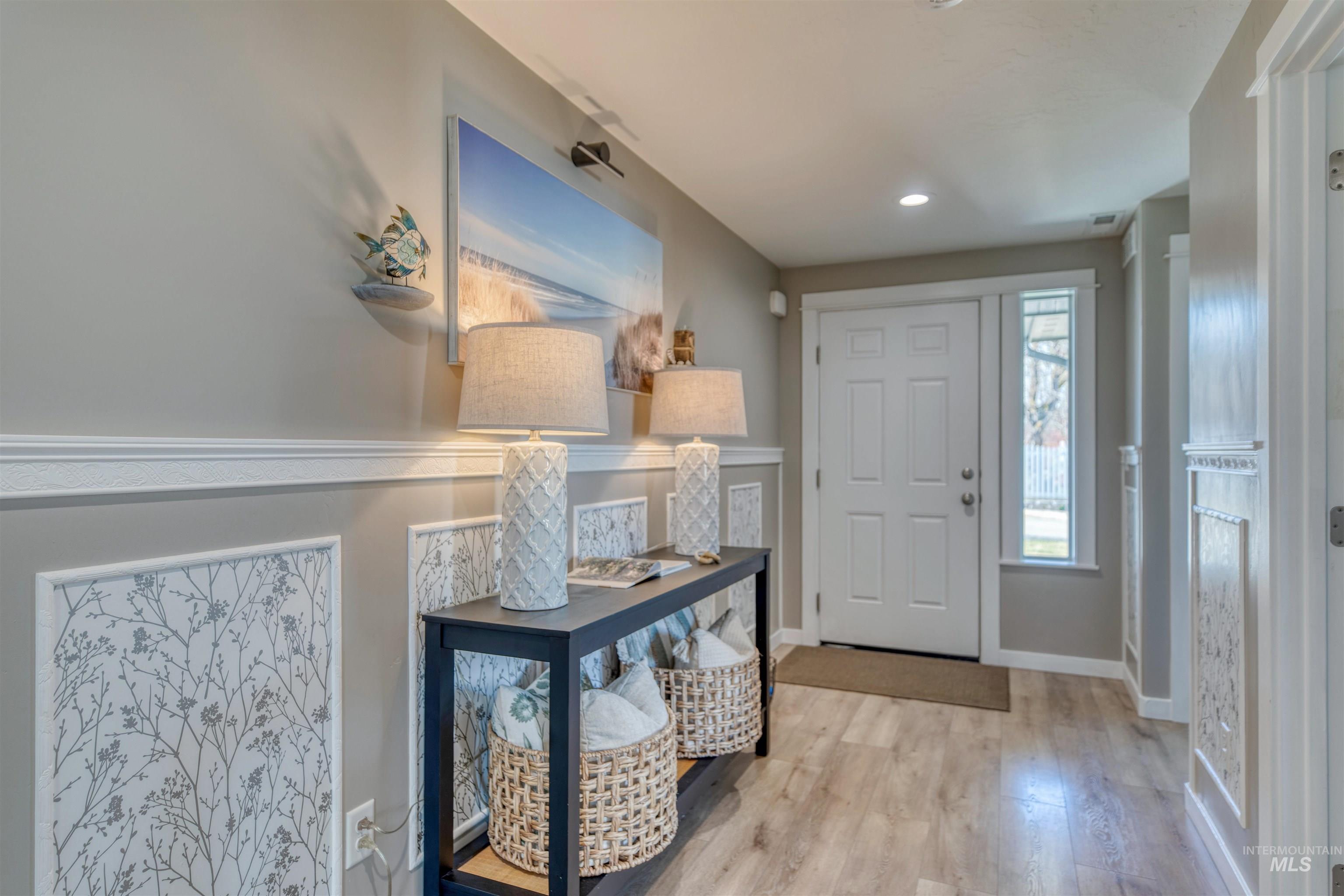 Entrance foyer with light wood-style floors and recessed lighting