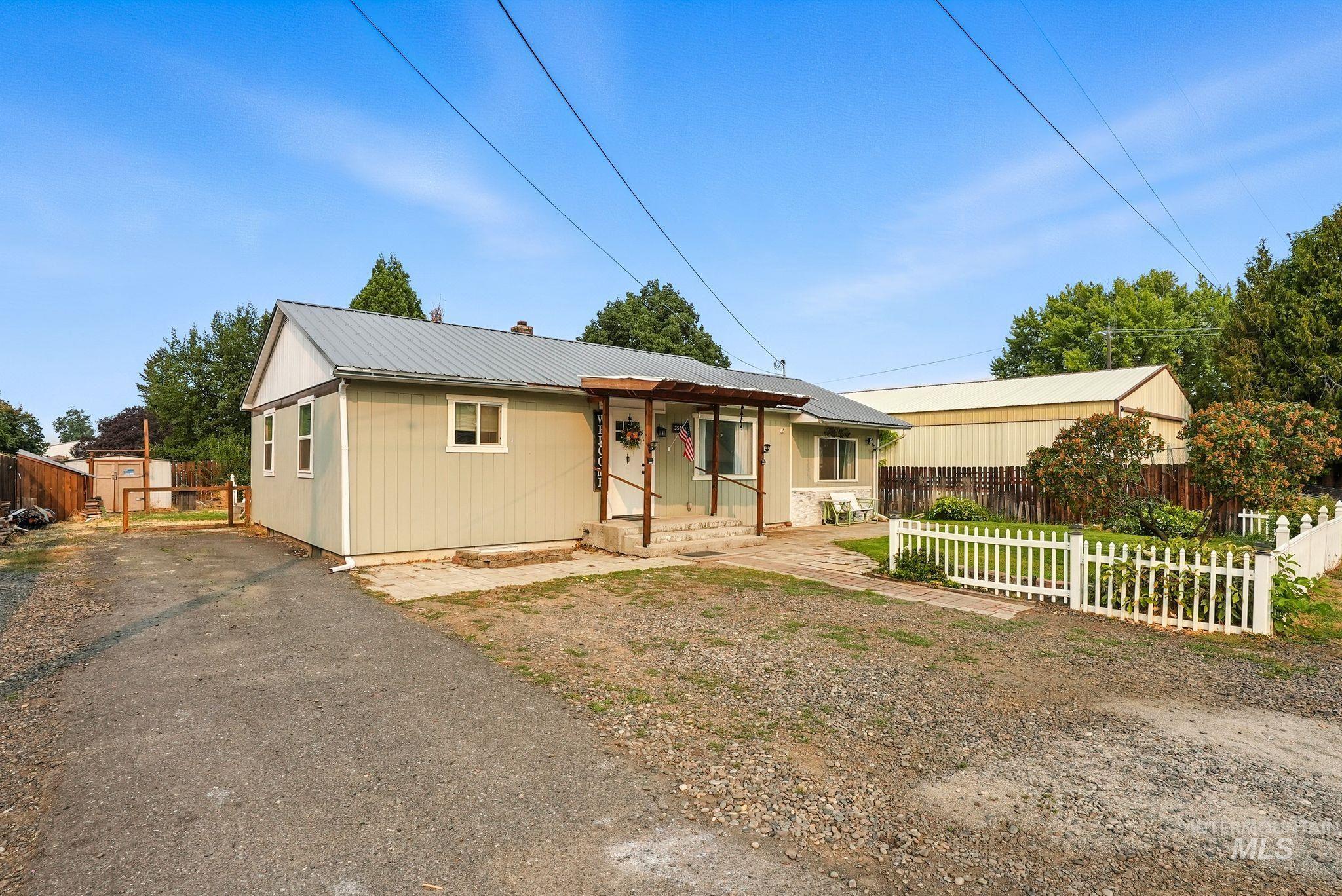 Single story home featuring a metal roof and a chimney