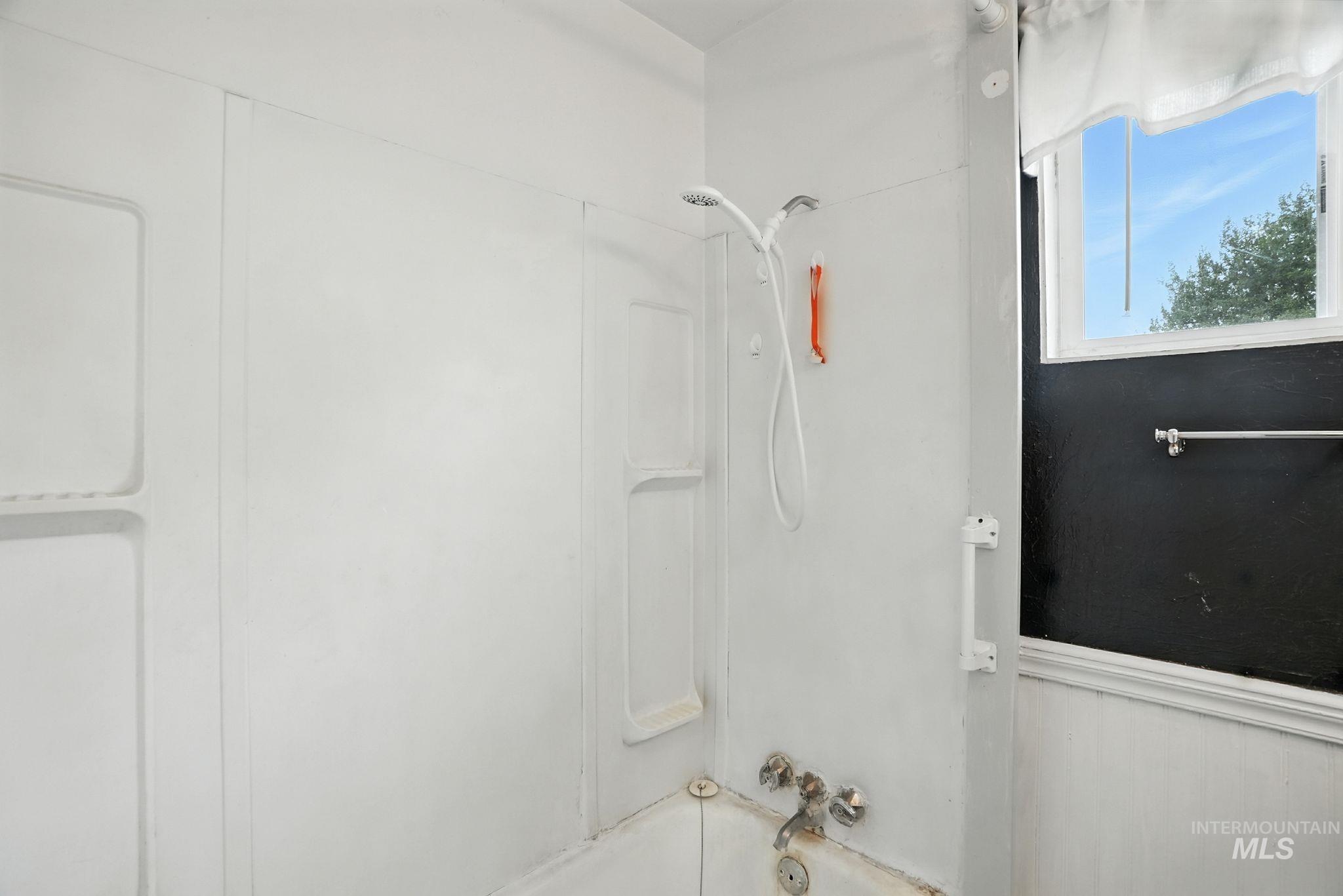 Bathroom featuring washtub / shower combination