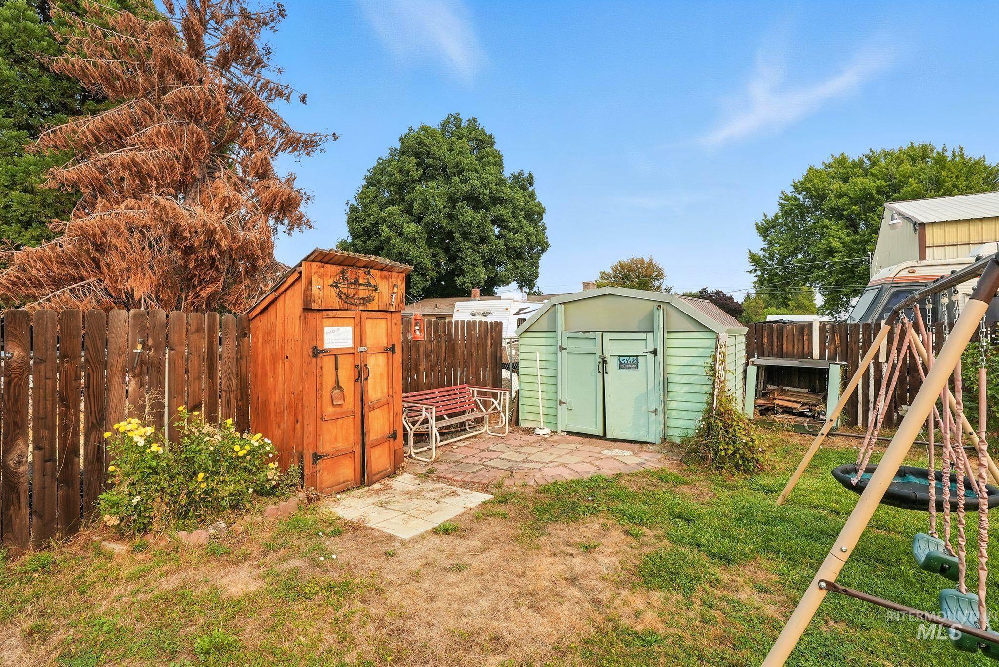 Fenced backyard with a storage shed and a patio