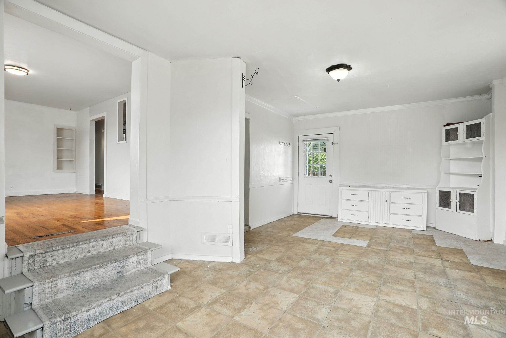 Spare room featuring ornamental molding and baseboards