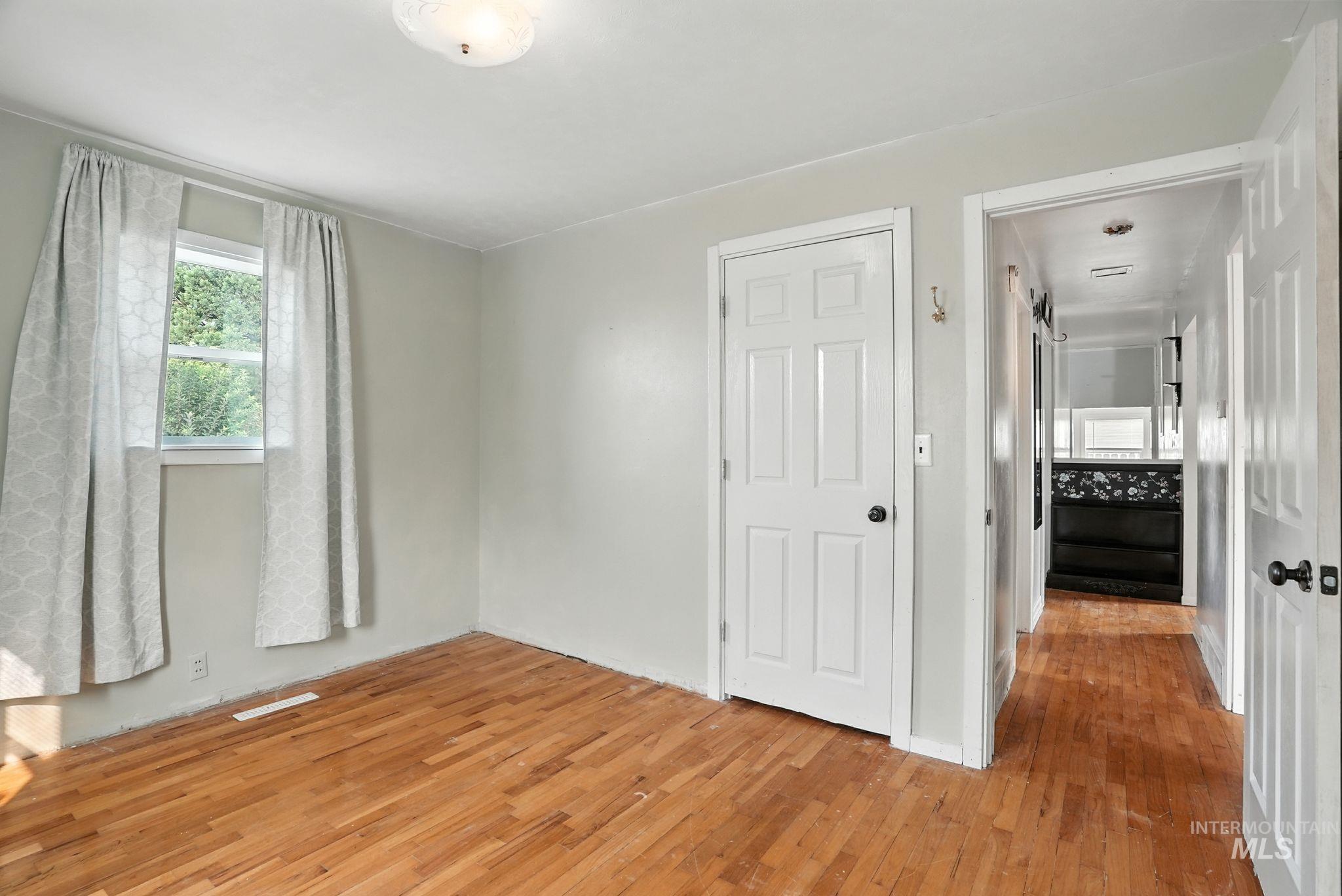 Unfurnished bedroom with light wood-style floors