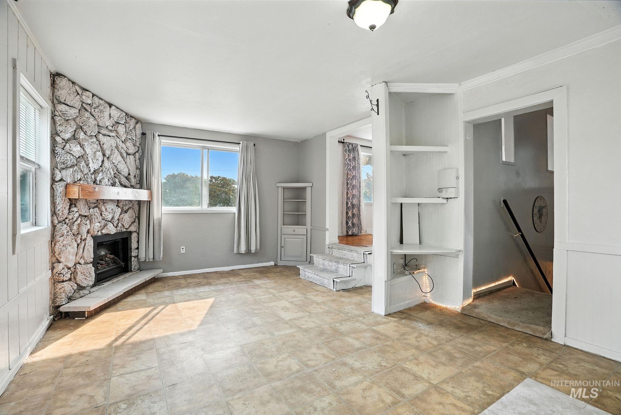 Mudroom featuring a fireplace and baseboards