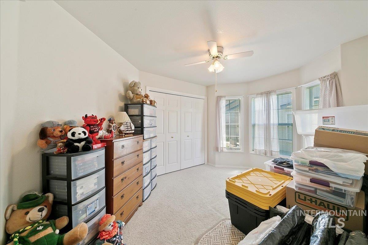 Bedroom with carpet flooring, a closet, and ceiling fan