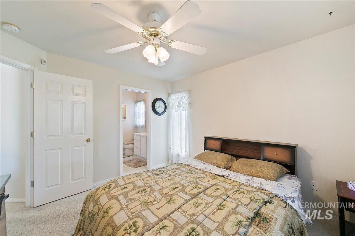 Master Bedroom featuring carpet, ceiling fan, and ensuite bathroom