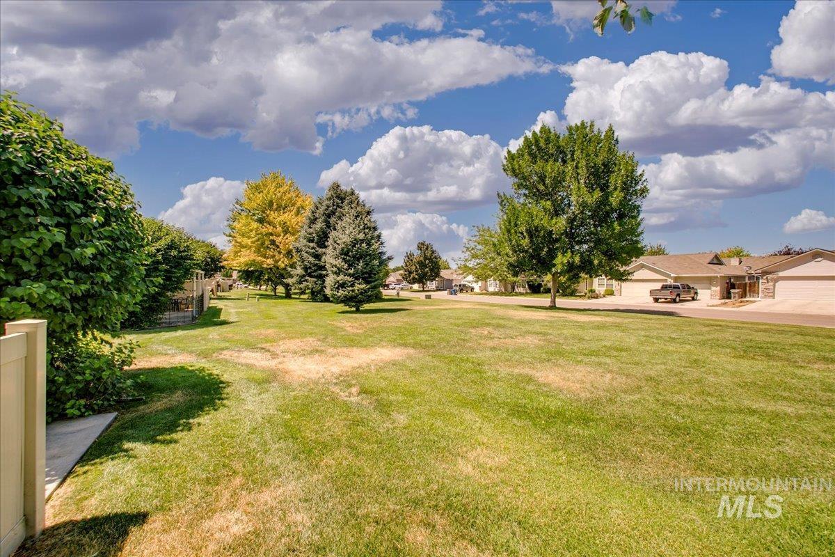 View of green lawn with a residential view