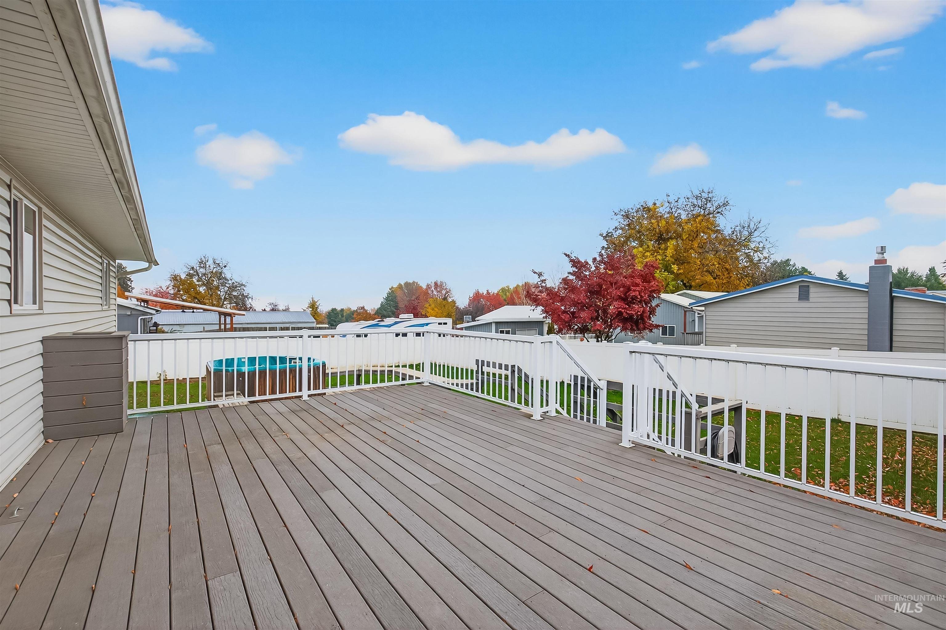 Wooden terrace featuring a residential view and a fenced backyard