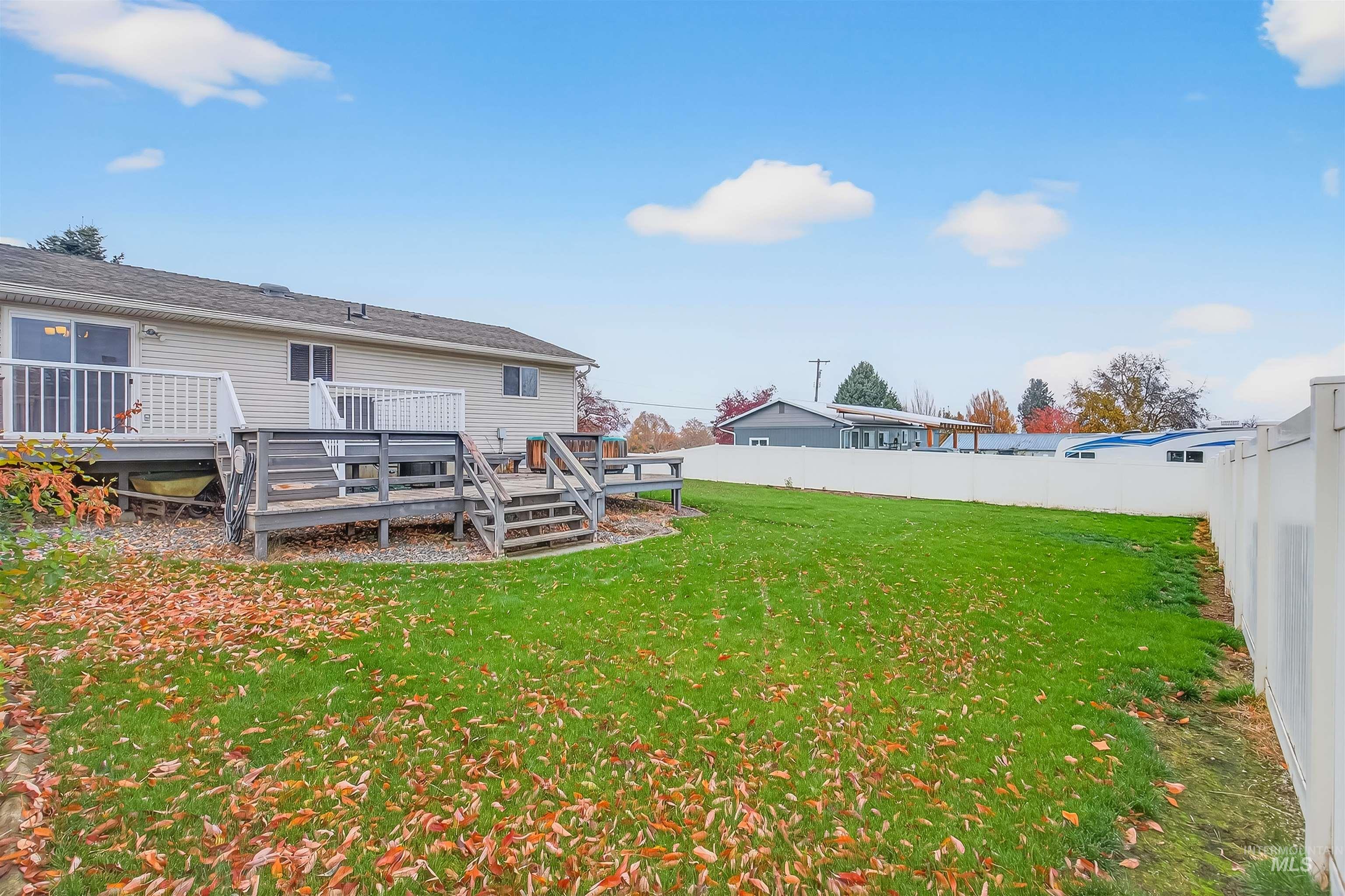 Fenced backyard featuring a deck