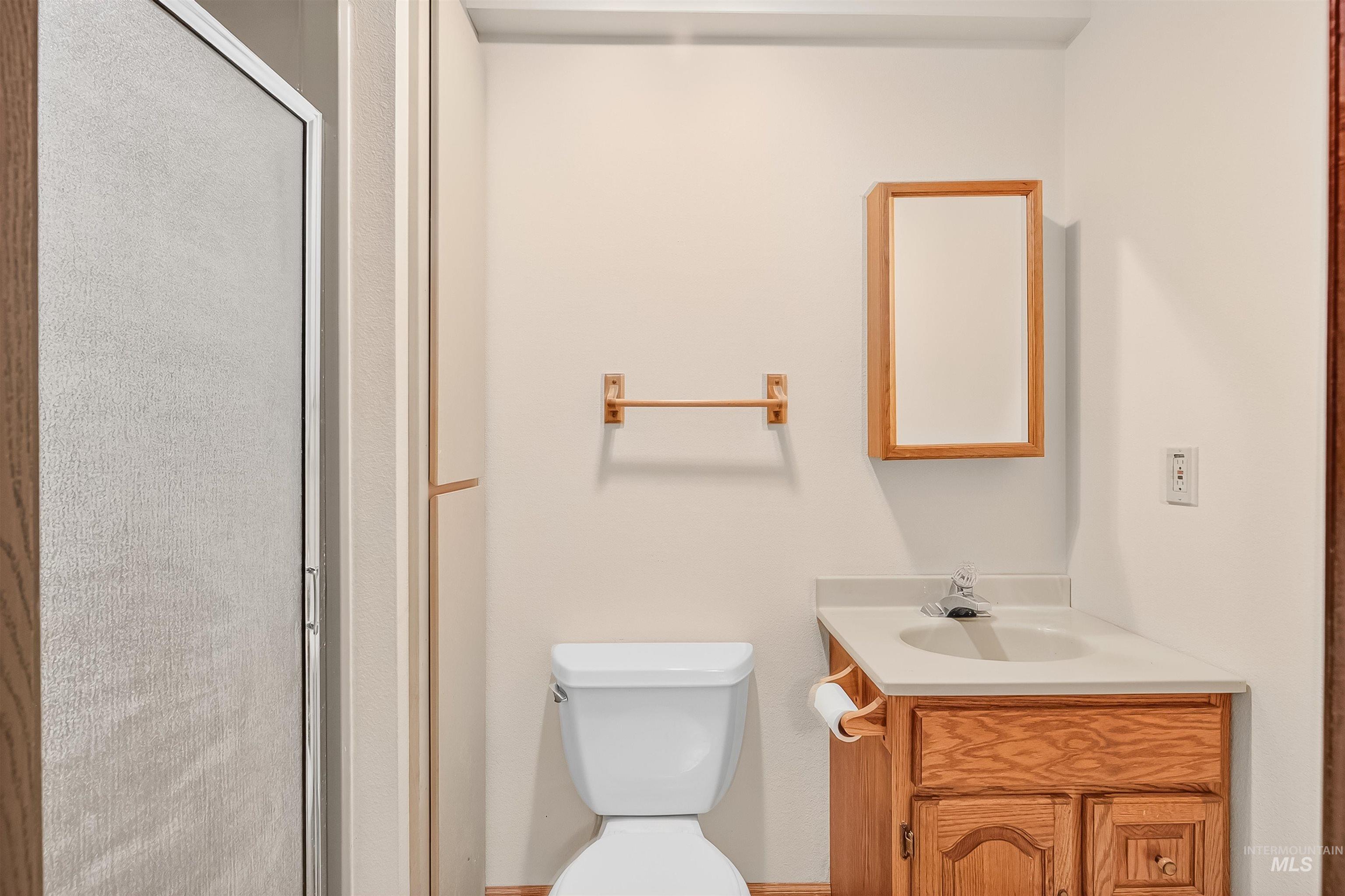Bathroom with vanity and a stall shower