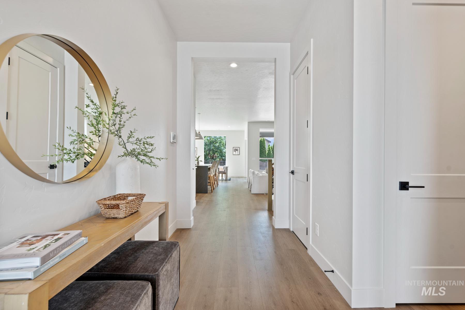 Hallway featuring light wood-style flooring and baseboards