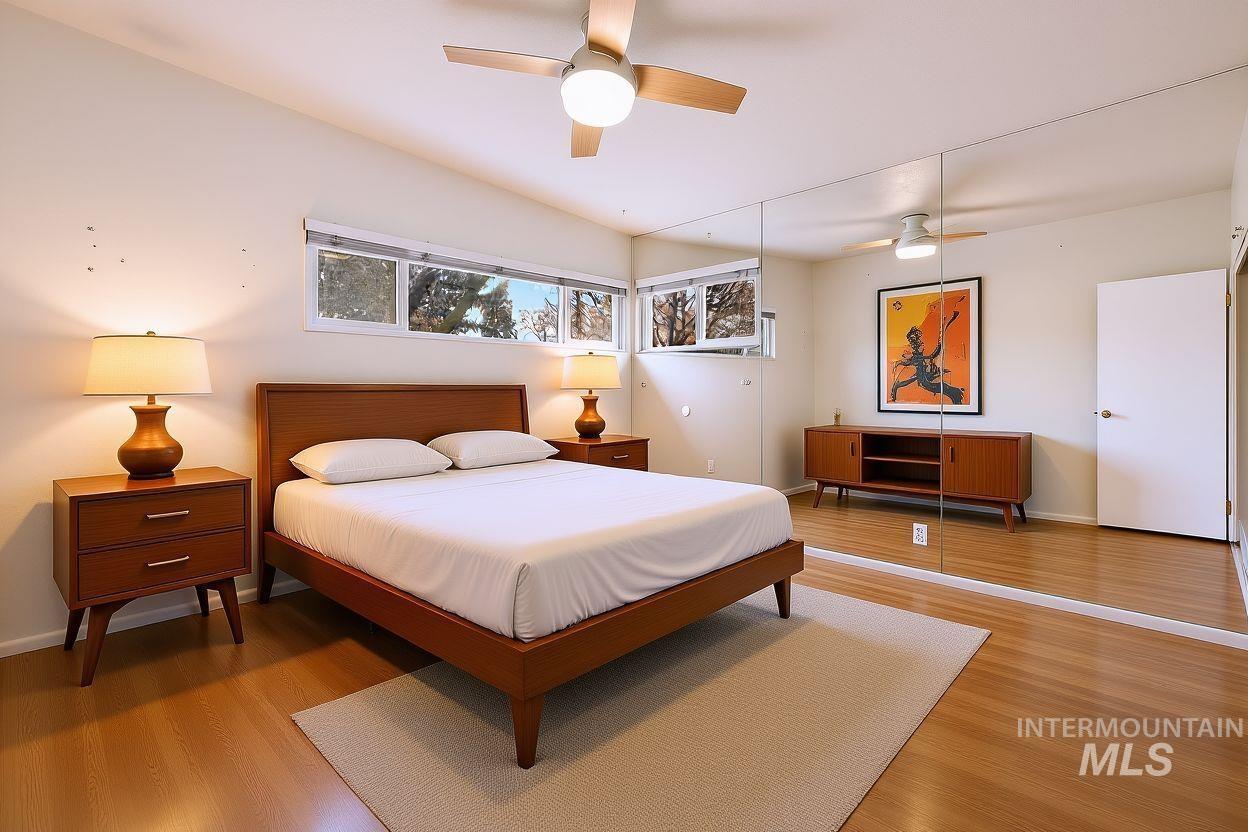 Bedroom with a ceiling fan and wood finished floors