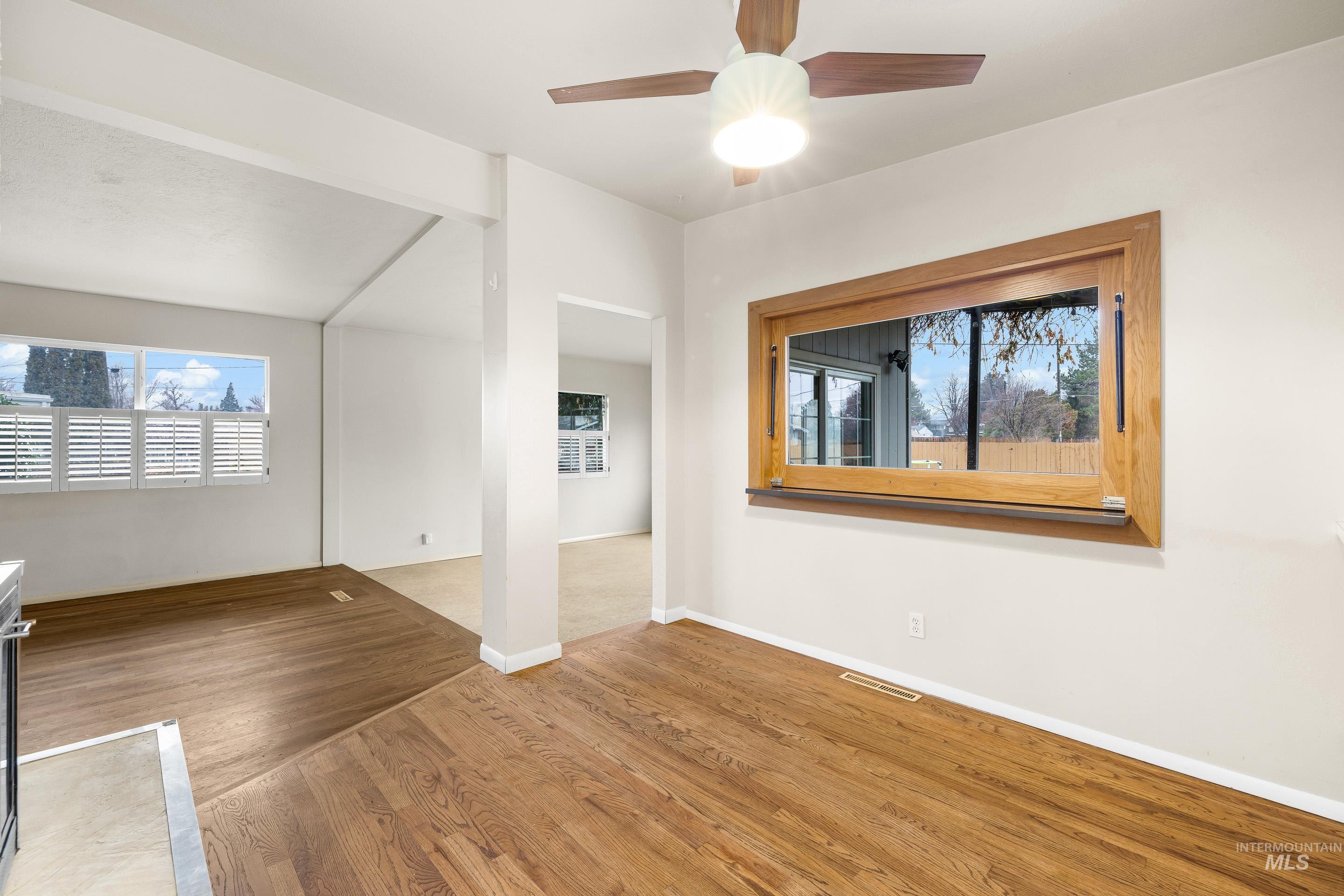 Unfurnished room with wood finished floors and ceiling fan