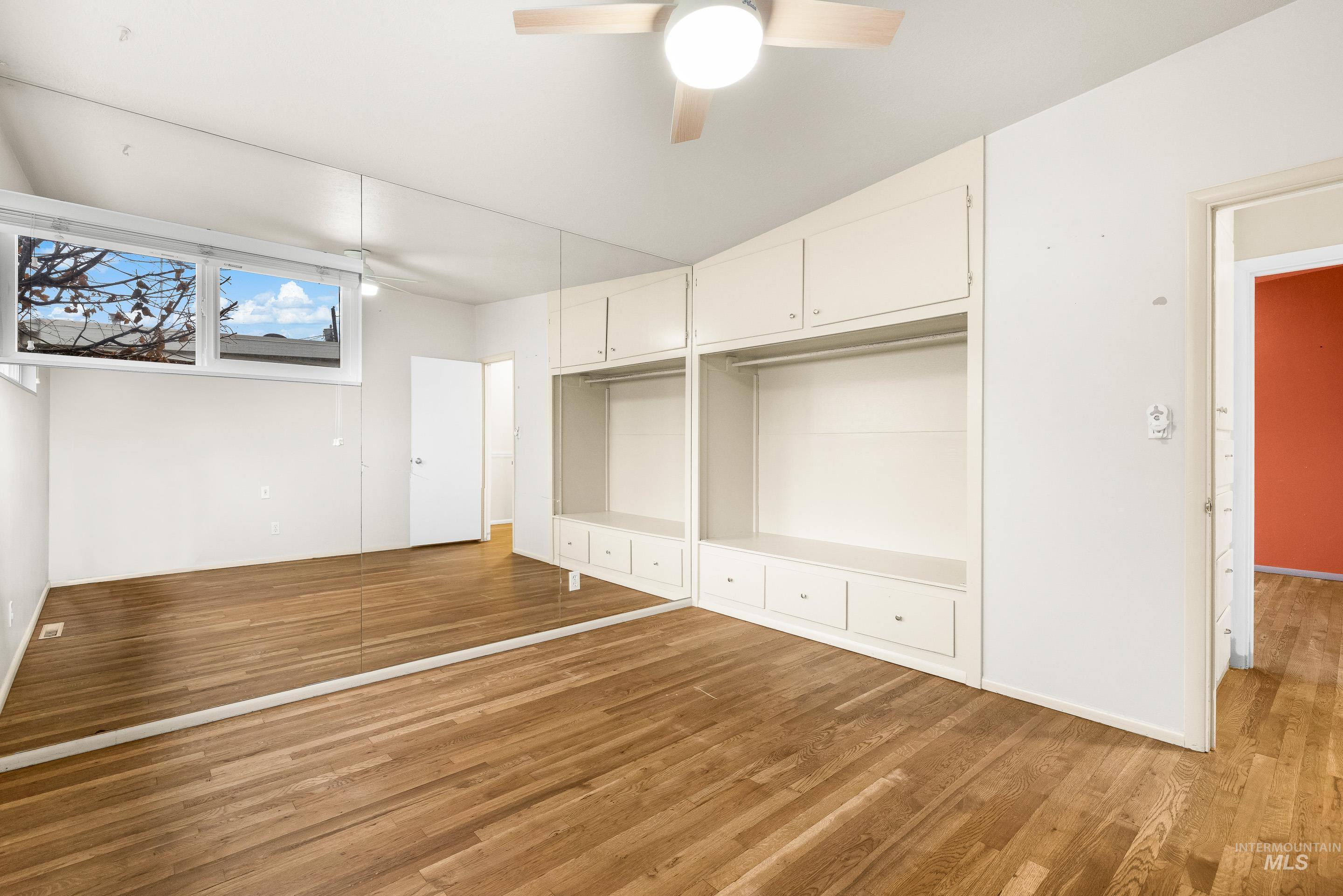 Unfurnished bedroom with light wood-style flooring, a ceiling fan, and a closet
