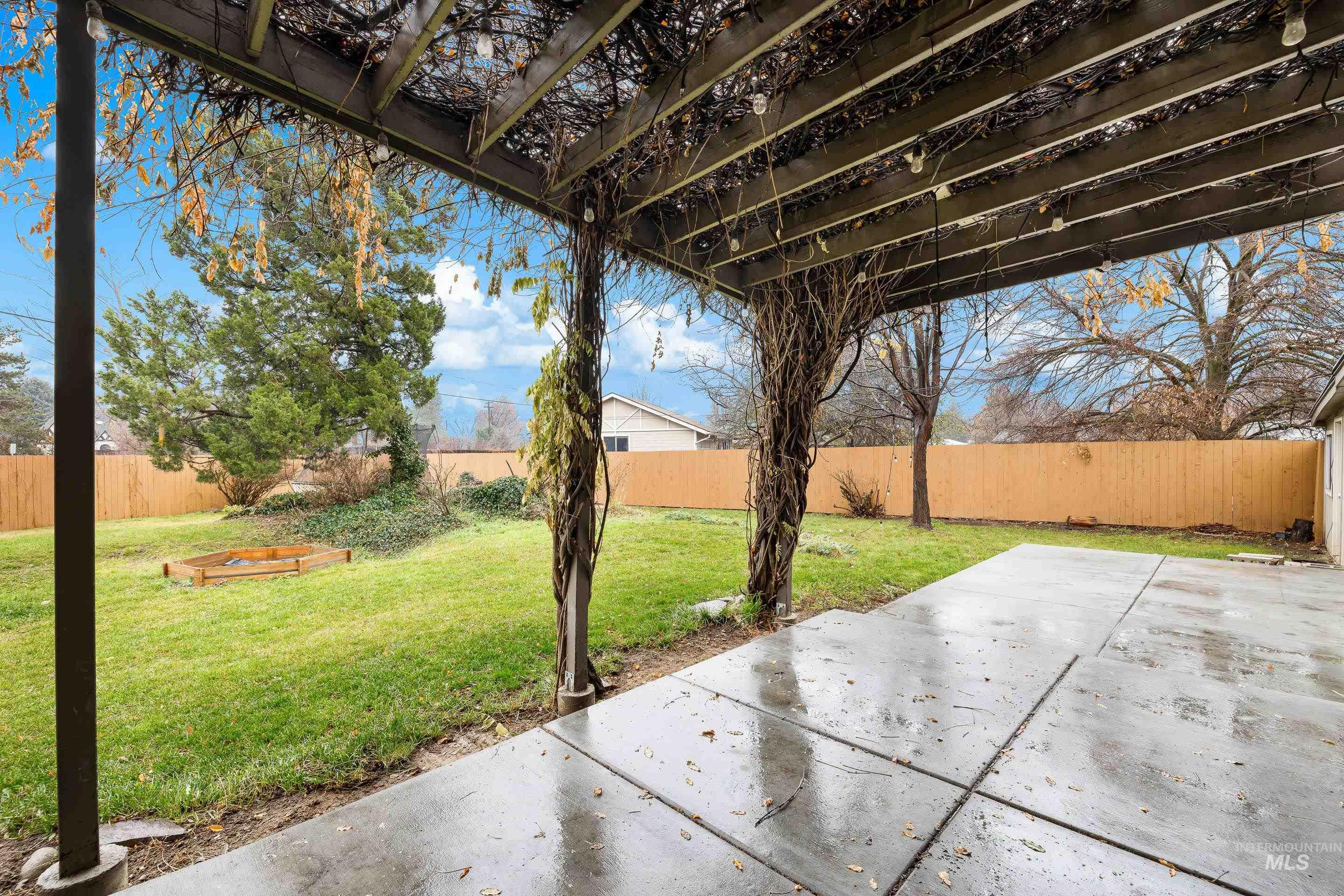 Fenced backyard featuring a patio