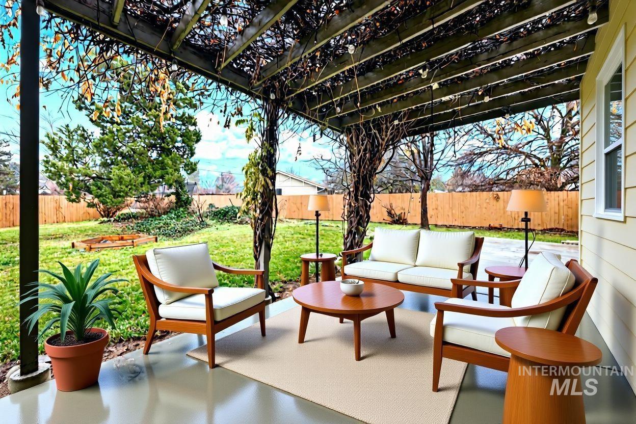 Fenced backyard with a patio area, outdoor lounge area, and a pergola
