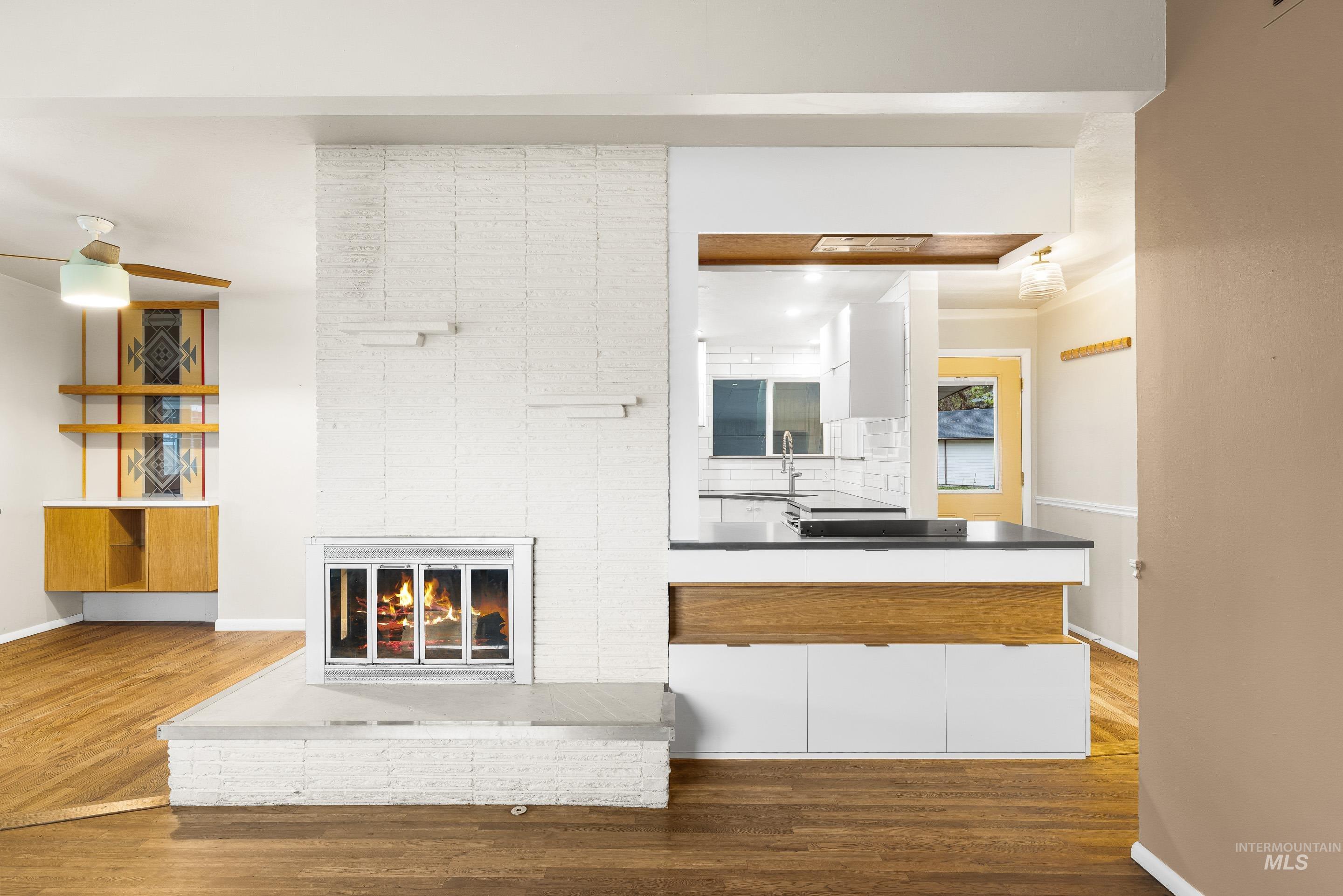 Living area with a fireplace and dark wood-style floors