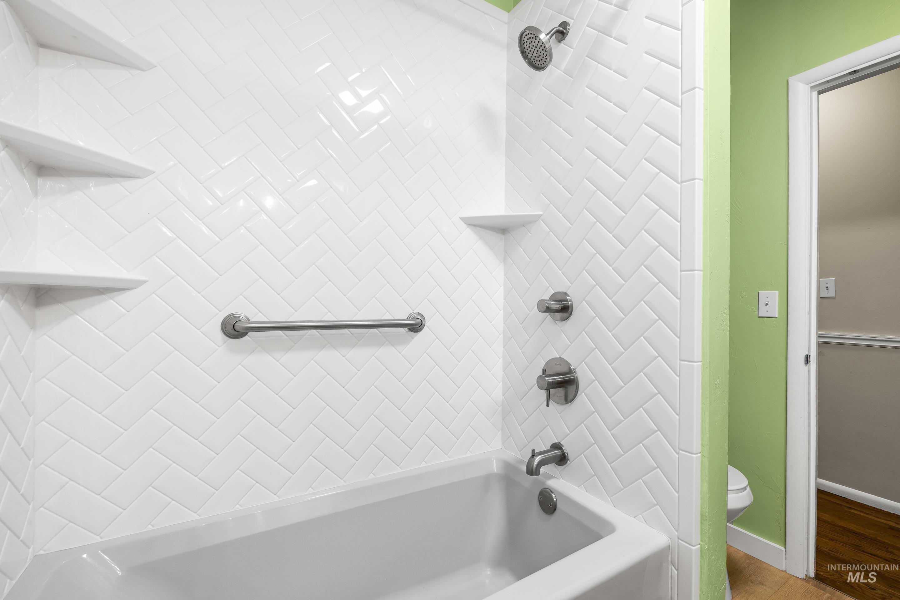 Full bathroom with shower / bath combination and toilet