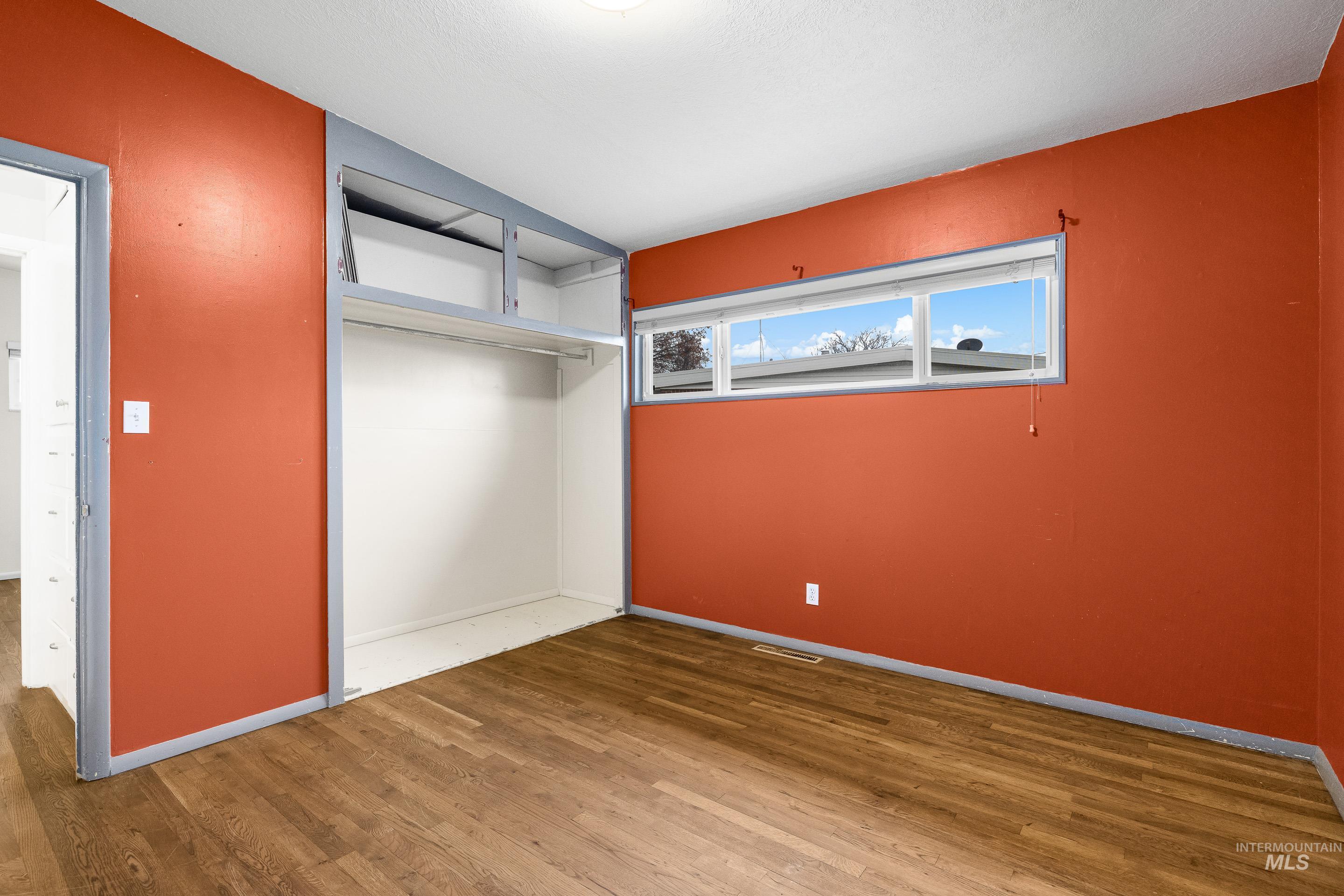 Unfurnished bedroom featuring a closet and wood finished floors