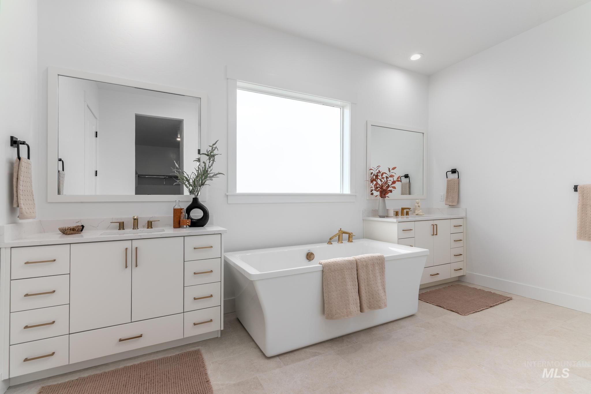 Freestanding soaking tub with gold-finish fixtures