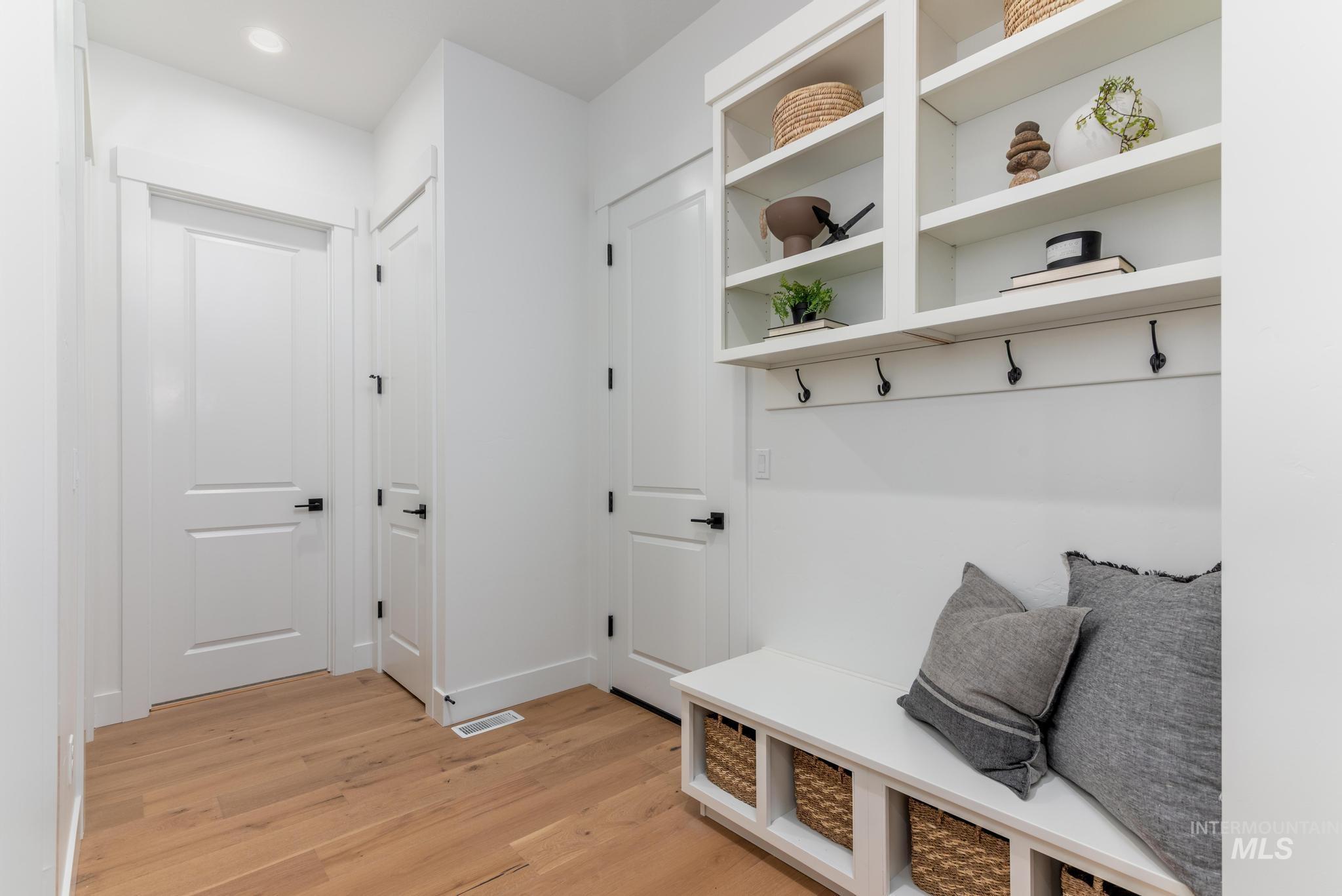 Built-in mudroom bench with cubby storage, integrated shelving, and coat hooks