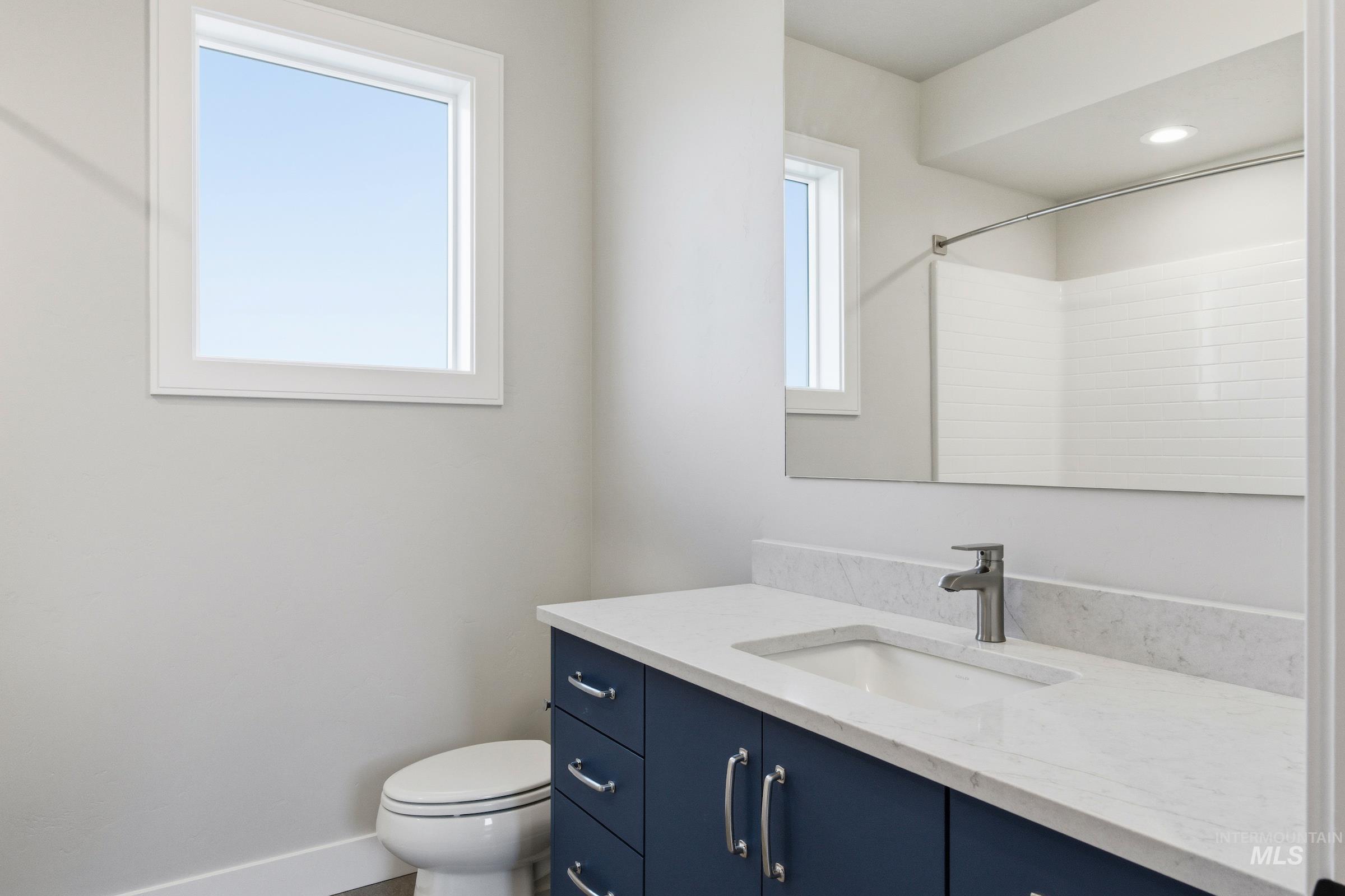 Bathroom featuring vanity and baseboards