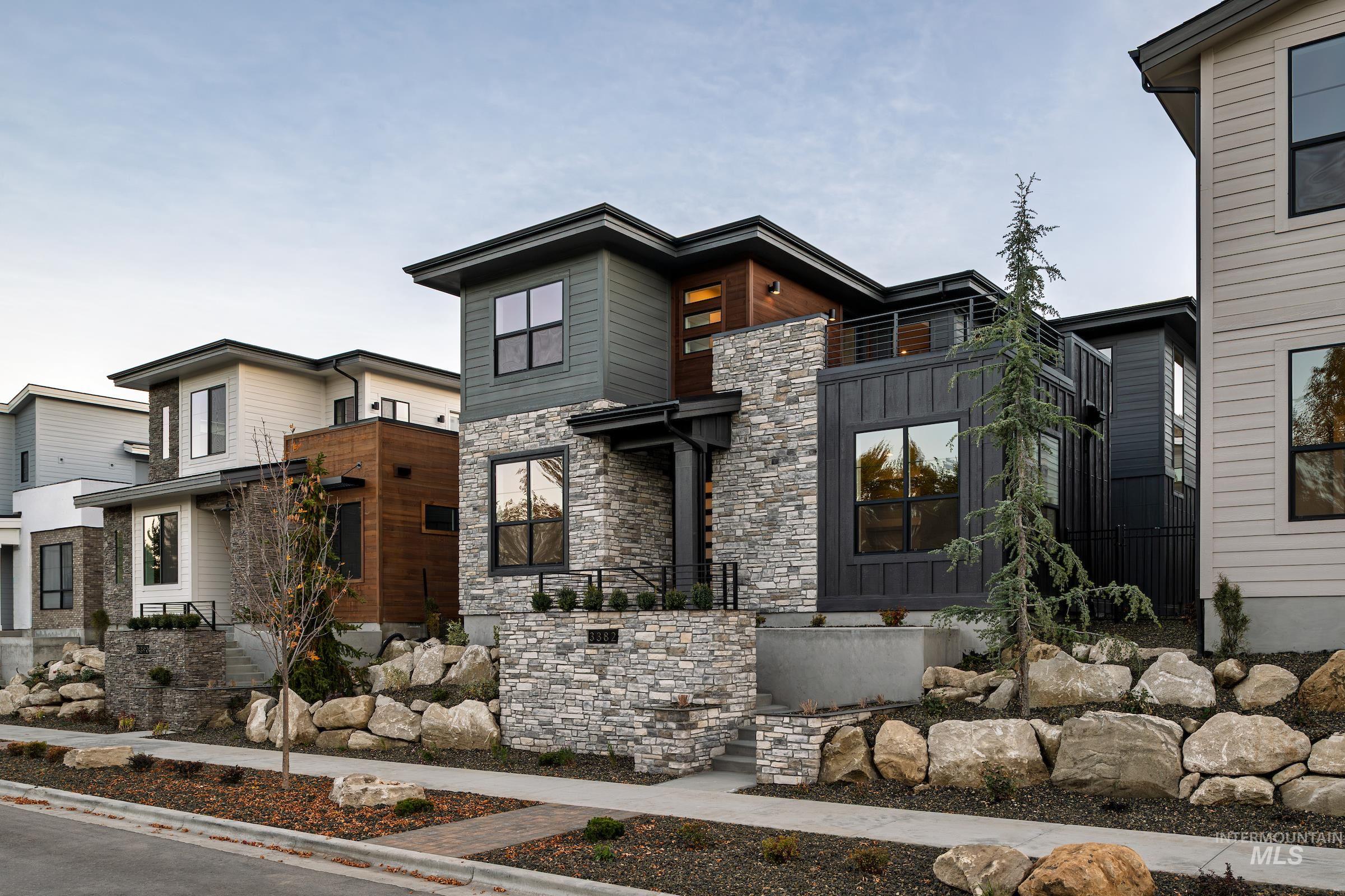 Contemporary house with stone siding and board and batten siding