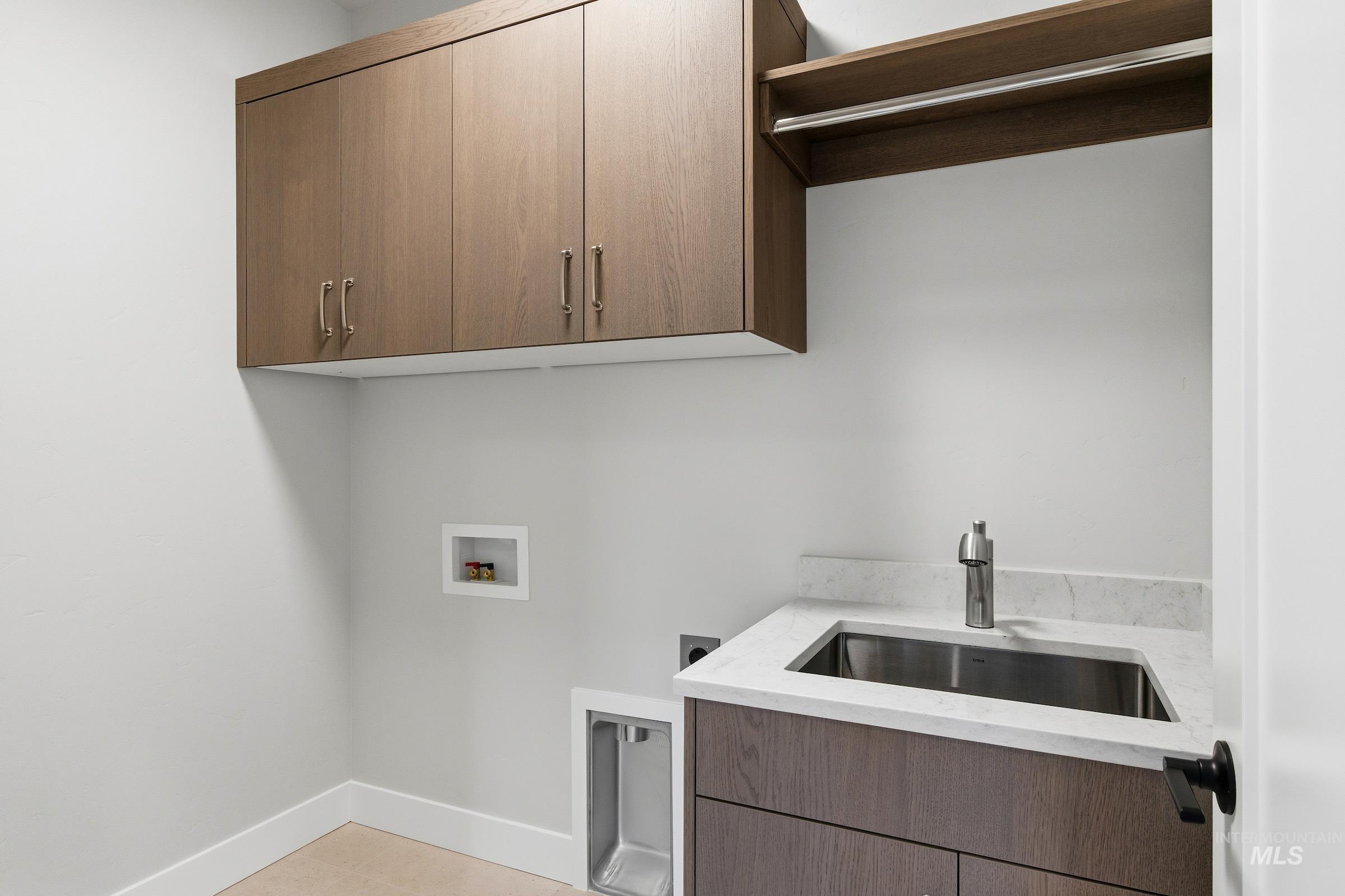 Laundry room with washer hookup and cabinet space