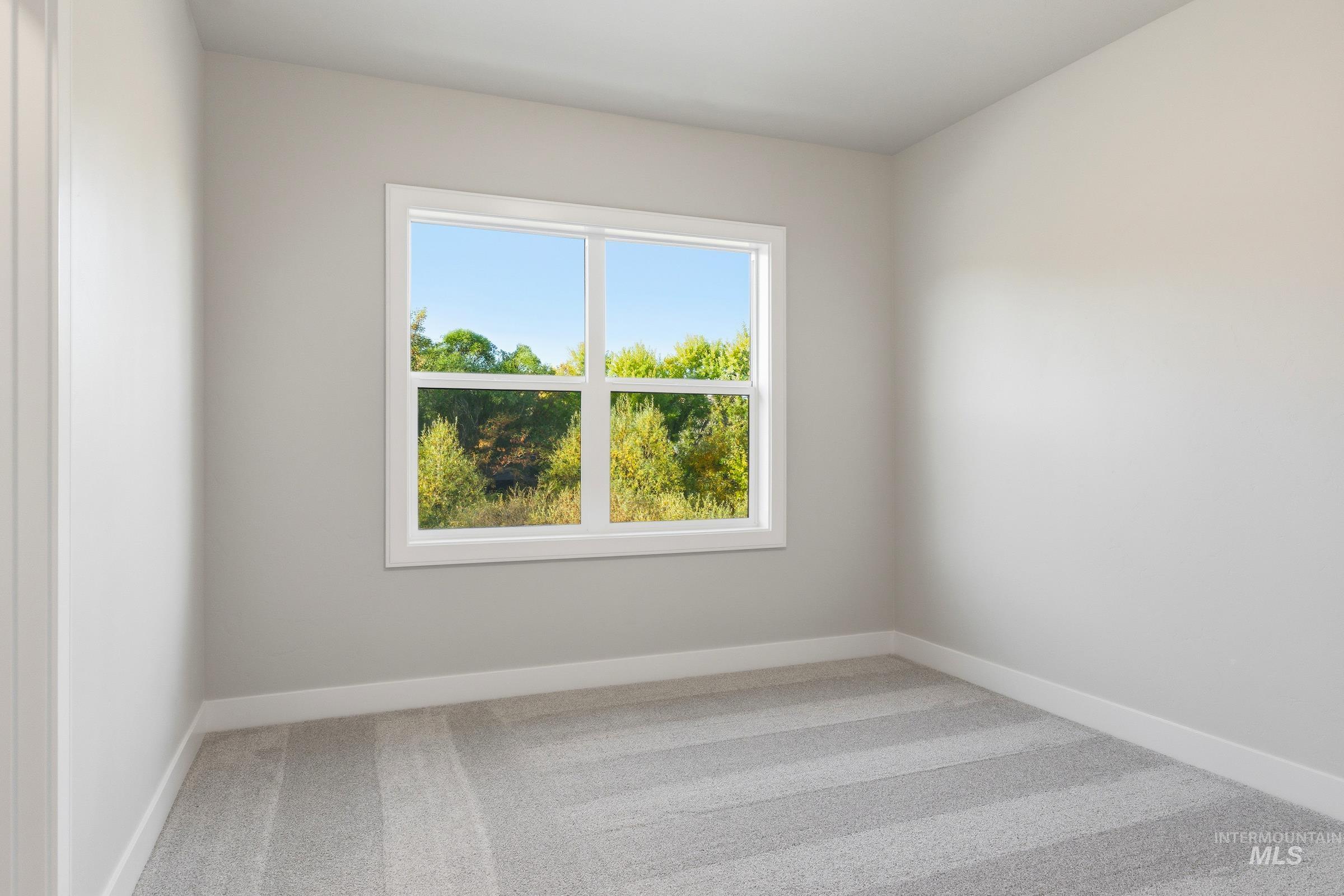 Carpeted empty room with baseboards