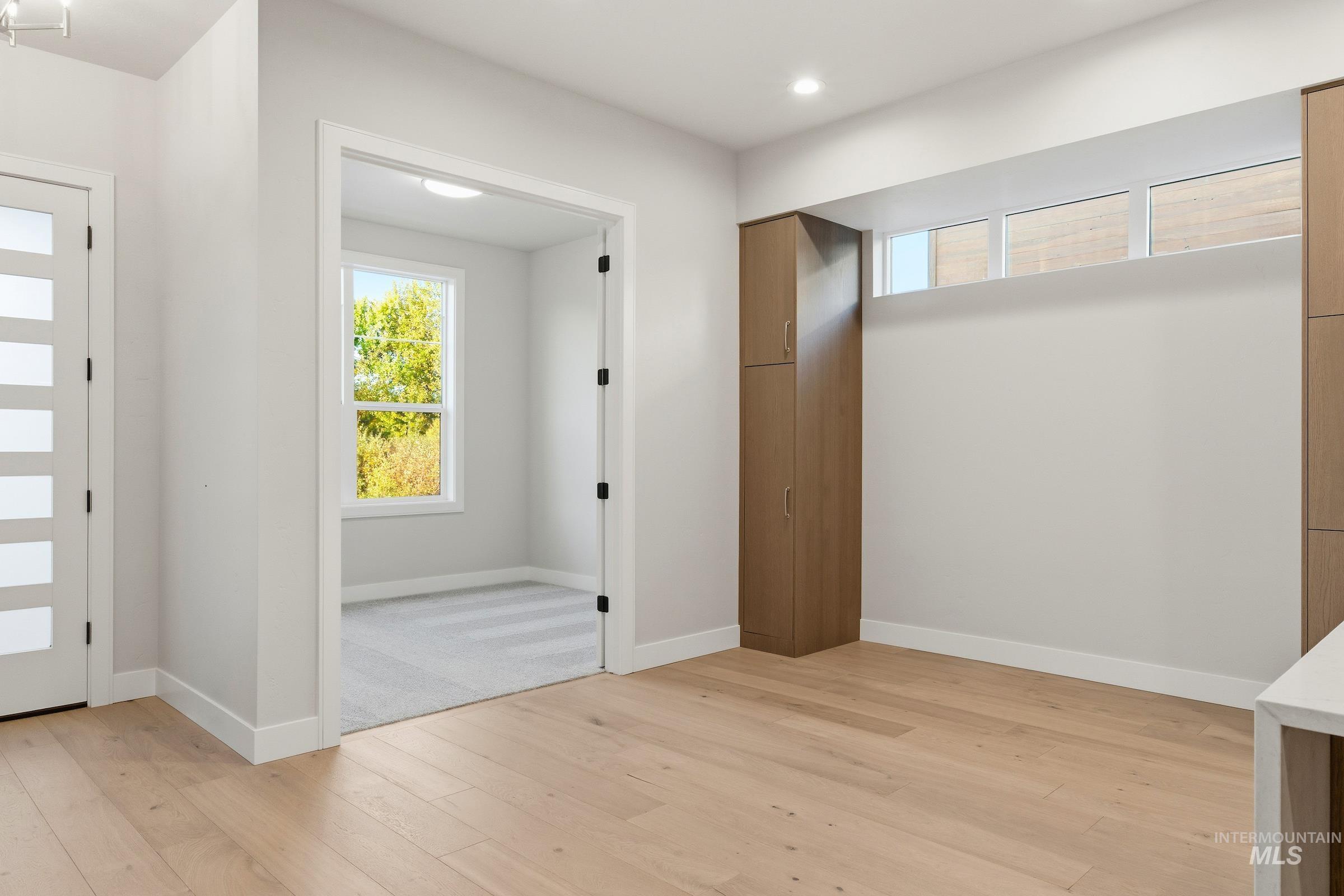 Foyer entrance featuring light wood finished floors and baseboards