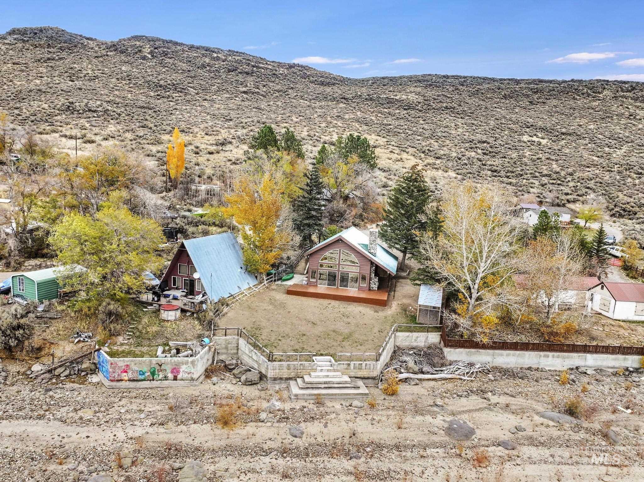 Aerial view of property and surrounding area featuring a mountain backdrop