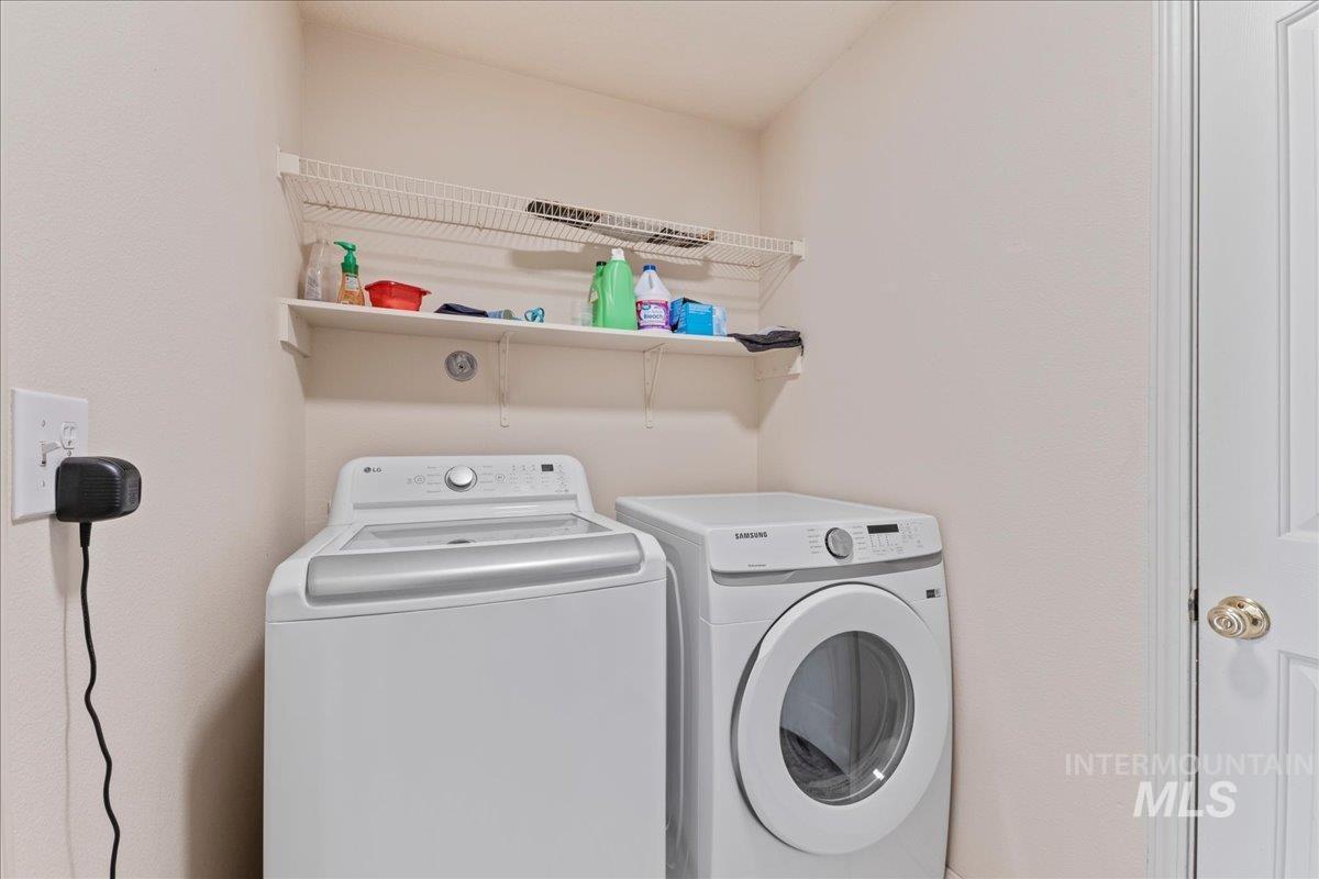 Laundry area with washing machine and clothes dryer