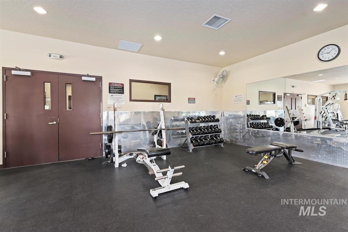 Gym featuring recessed lighting and a textured ceiling