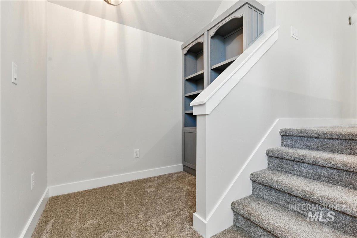 Stairway with carpet floors and baseboards