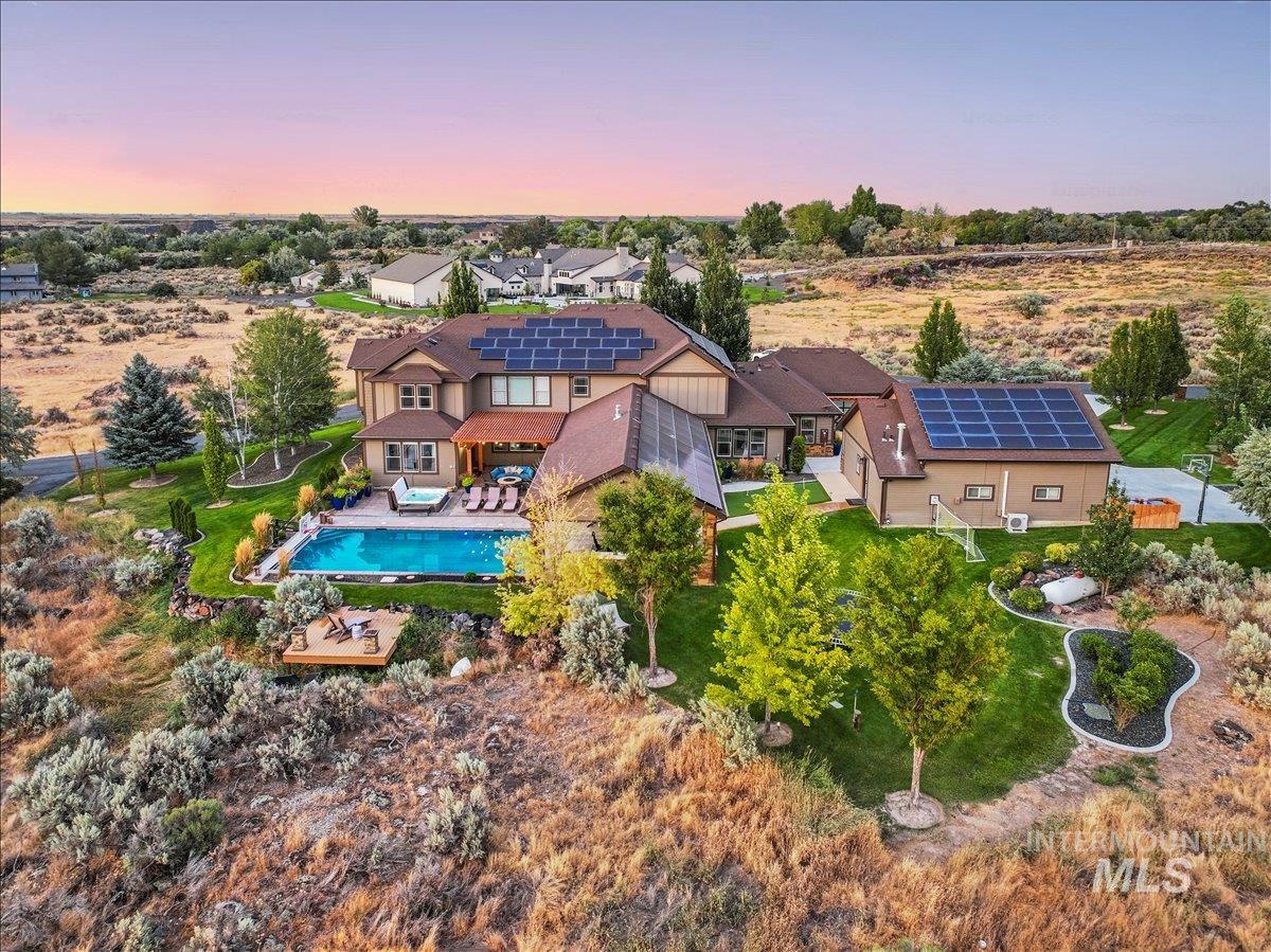 Aerial view at dusk of view of pool