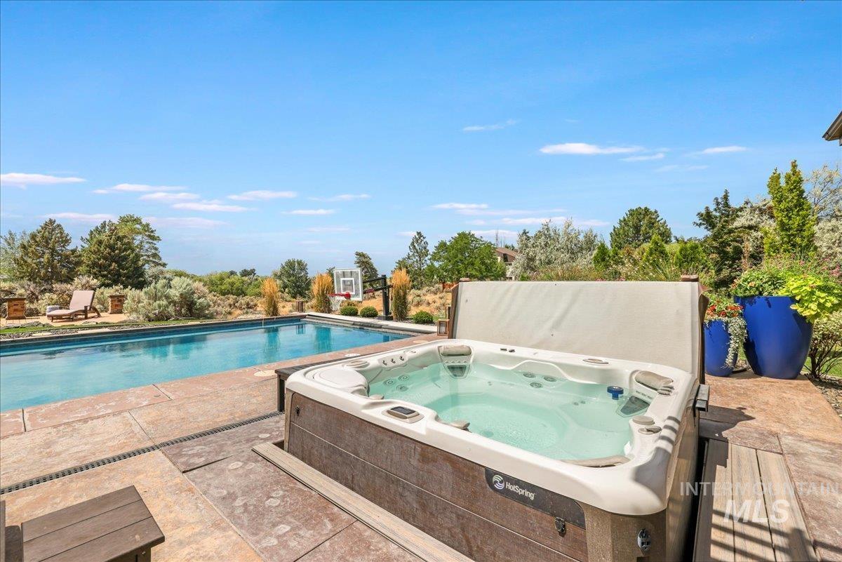 Swimming pool featuring a hot tub