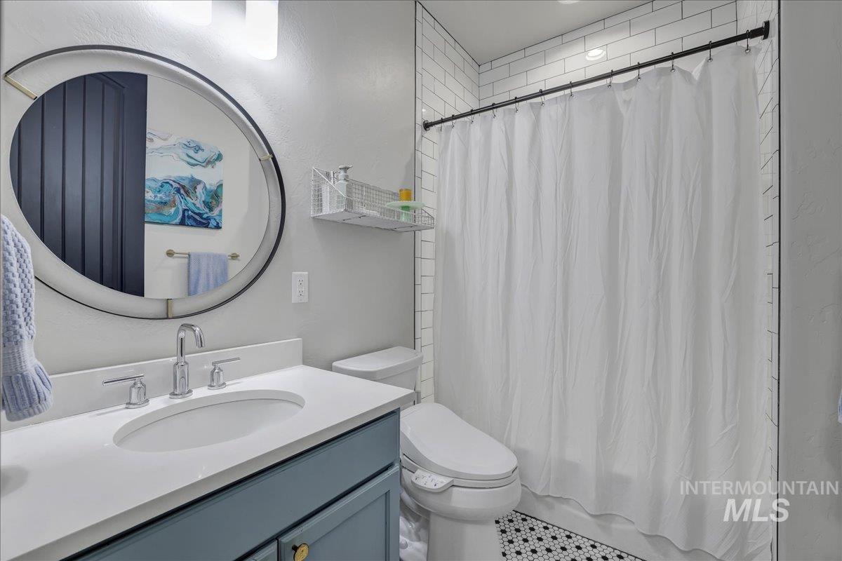 Full bath with vanity and shower / bath combination with curtain