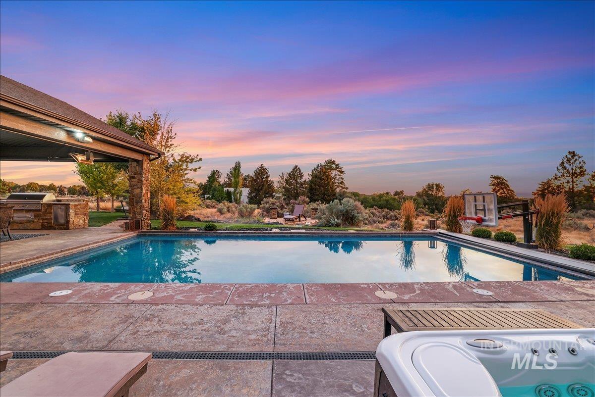 Outdoor pool featuring a patio area and exterior kitchen