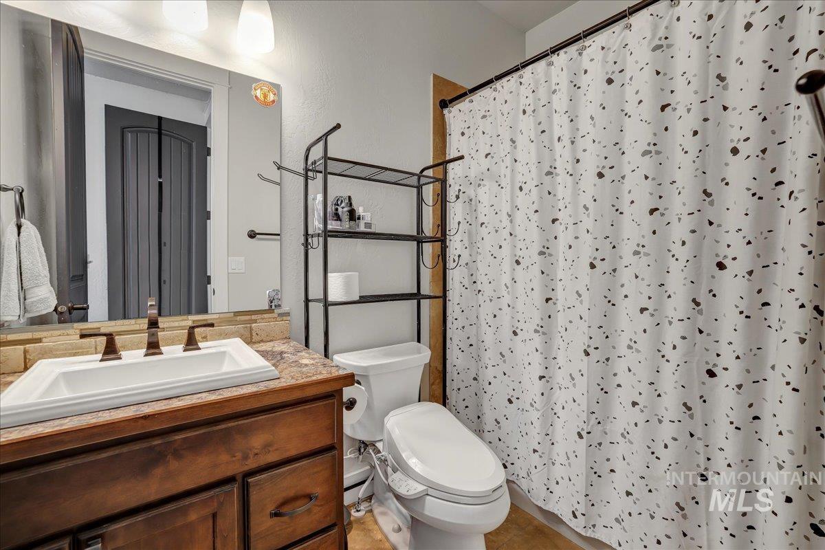 Full bath with vanity, a shower with curtain, and tile patterned floors