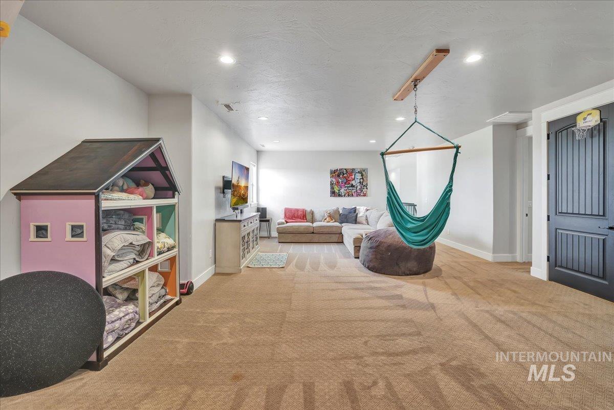 Rec room with carpet, recessed lighting, and a textured ceiling