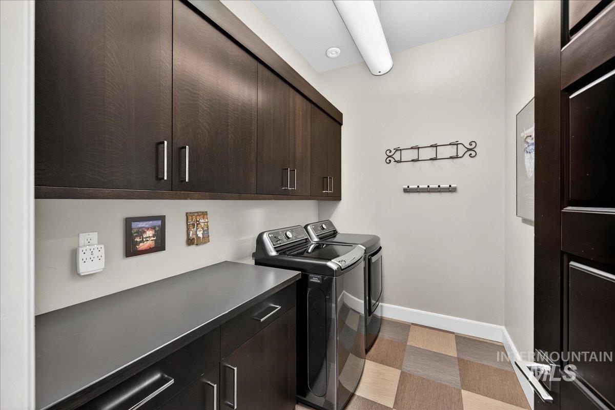 Laundry area with independent washer and dryer, cabinet space, and light carpet