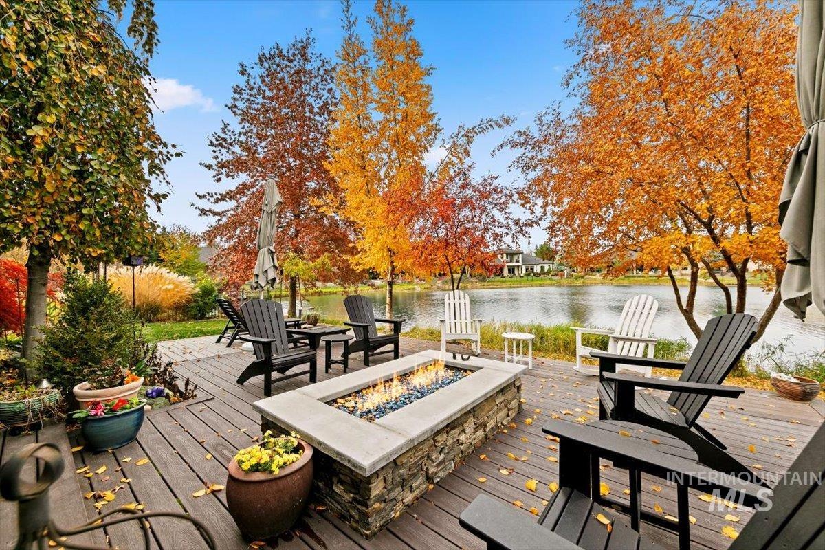 Wooden deck with a water view and an outdoor fire pit